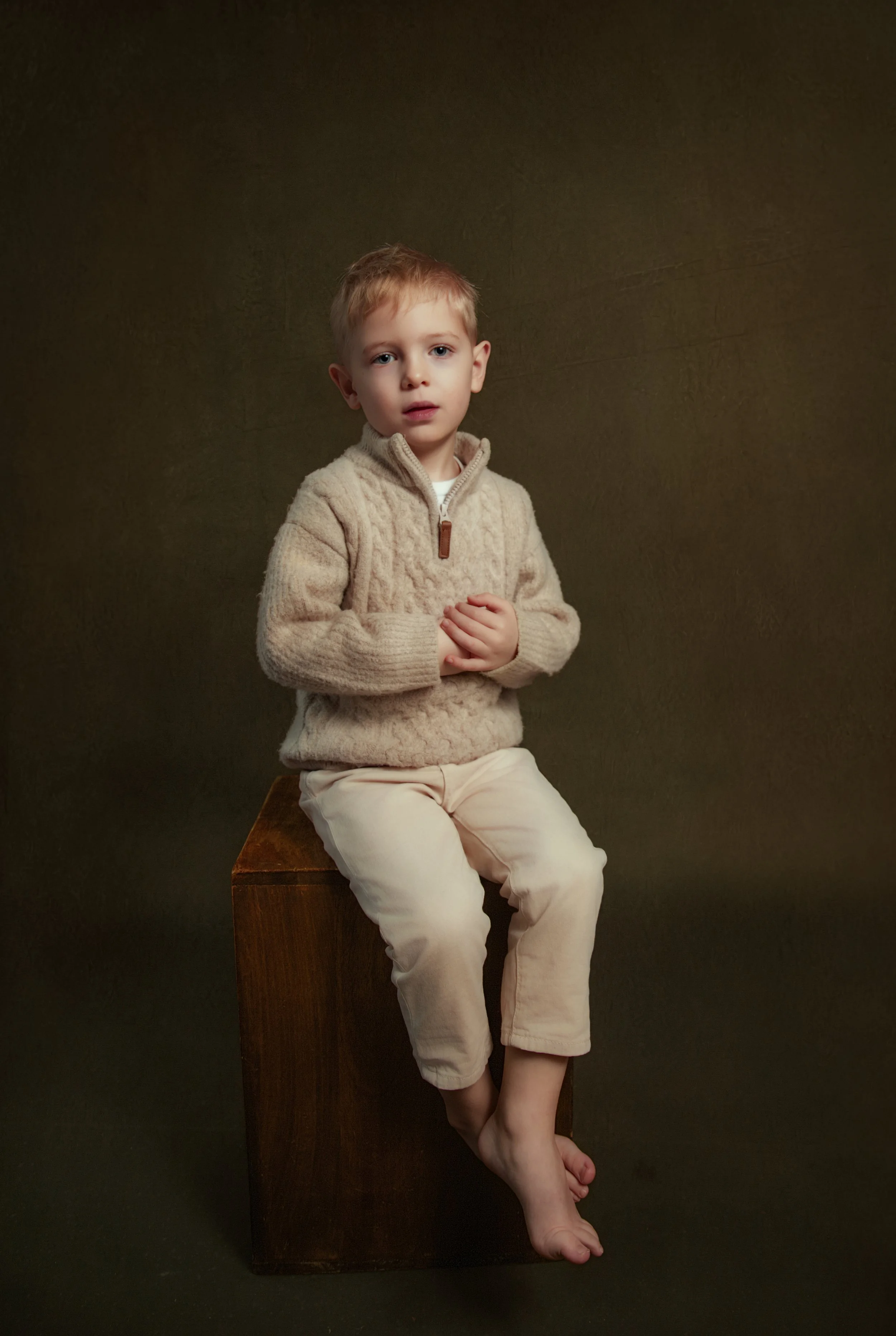classic stunning portrait of a young boy sat on a stool in bury by family and child photographer lancashire