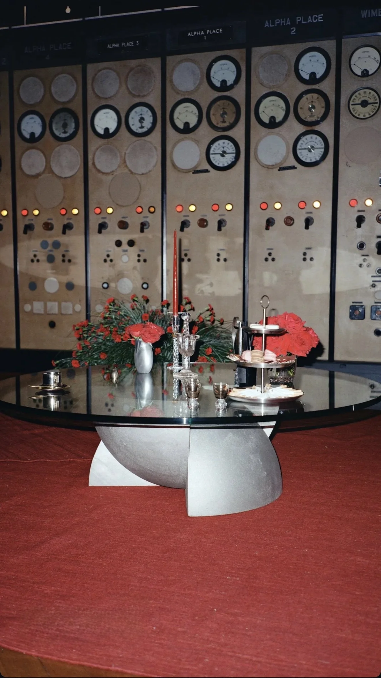 Event table styling red flowers silver candles.JPG