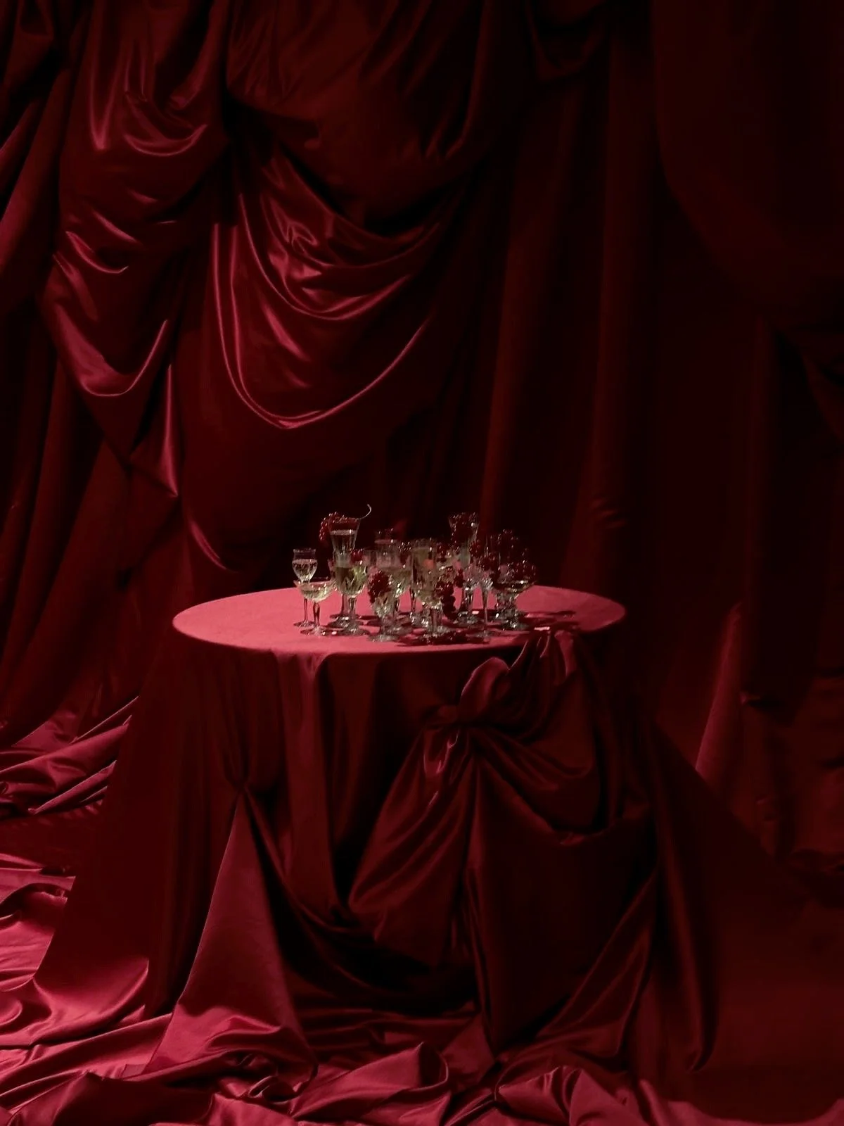 Red fabric draping champagne event table.JPG