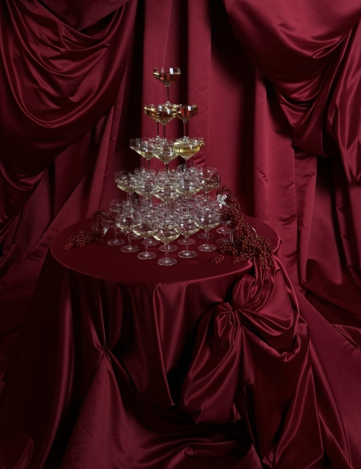 Red material draping table champagne tower.JPG