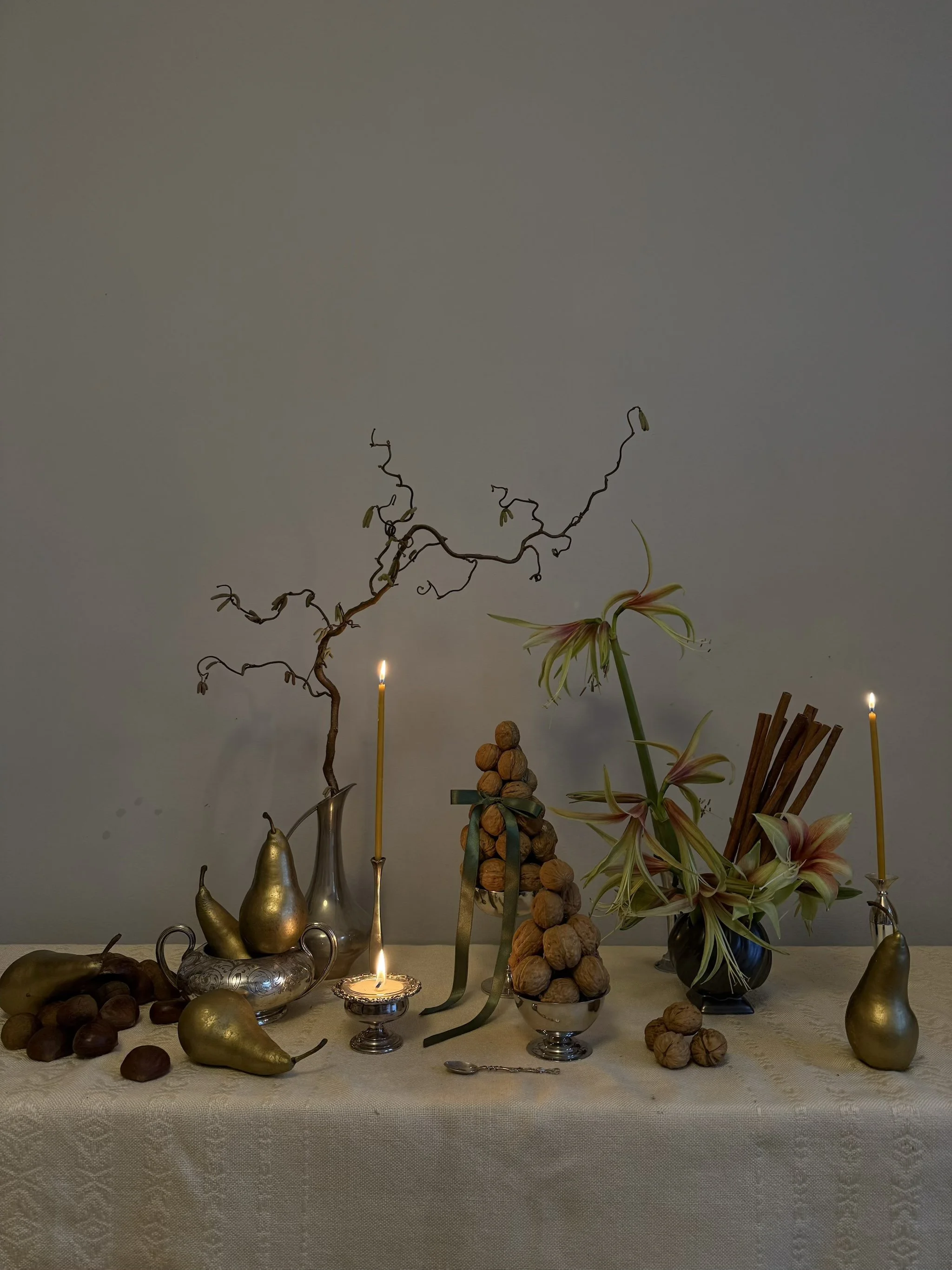 Creative concept Christmas table setting flowers silver wear candle arrangement.jpeg