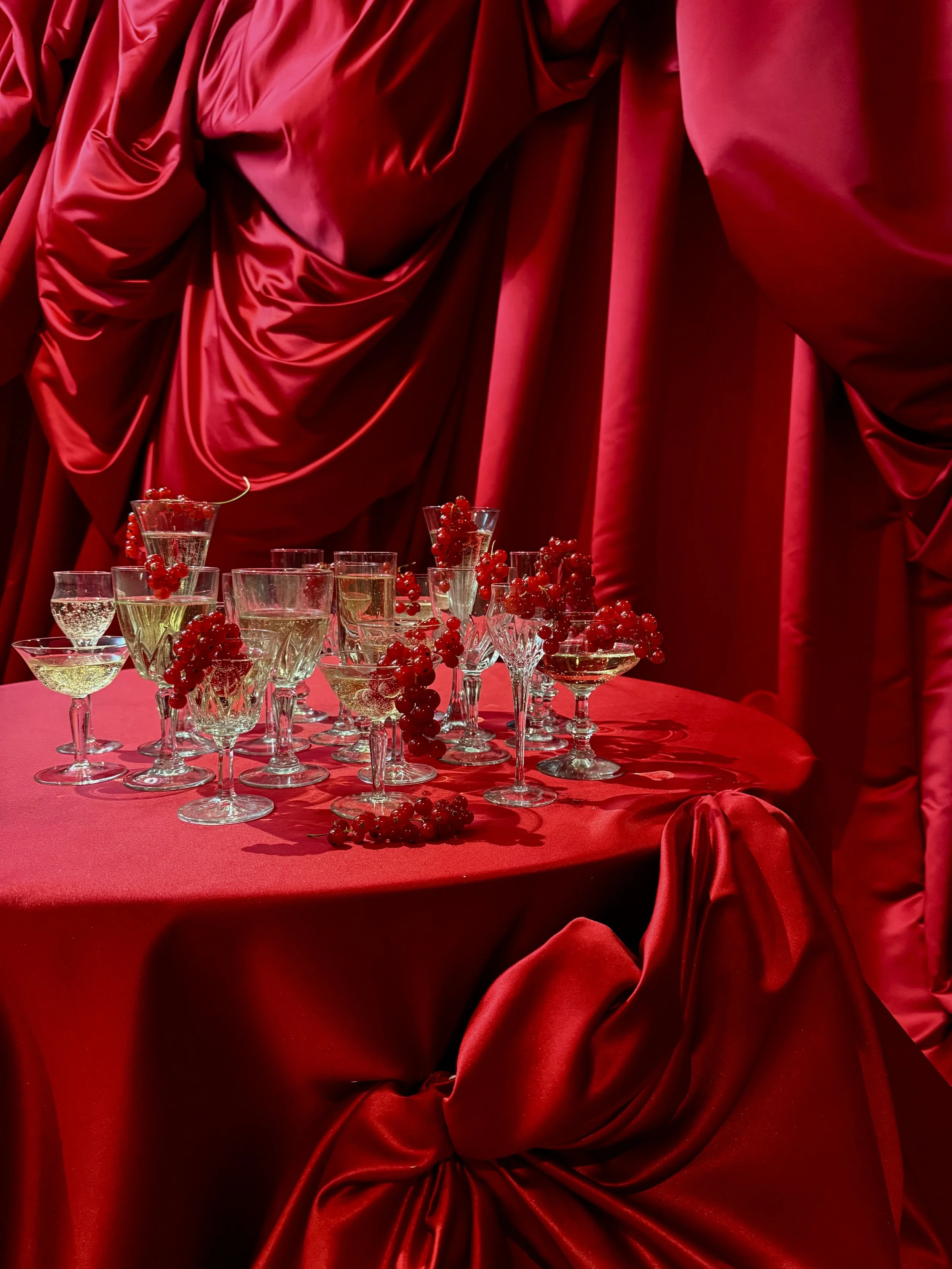 Red fabric draping styling champagne table.jpeg