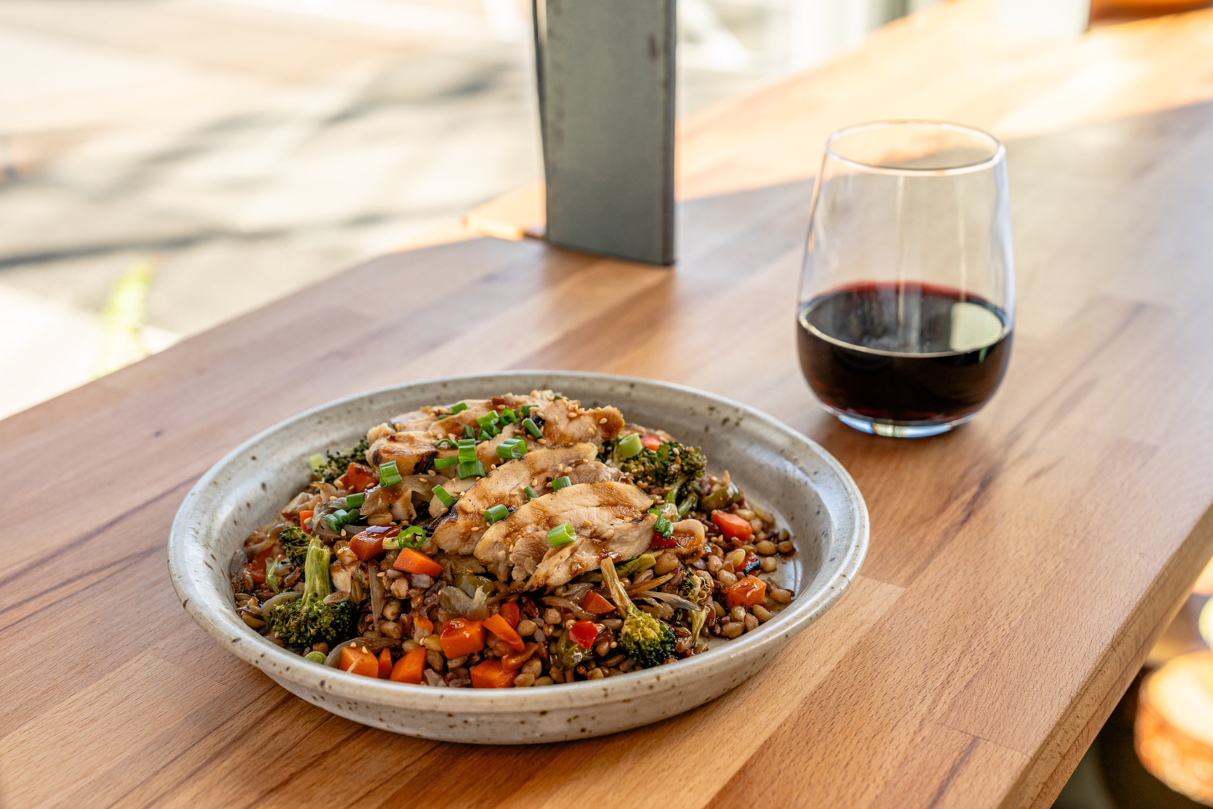 Exclusive Menu Item for Arete At The Line Experience Chicken grain bowl and wine