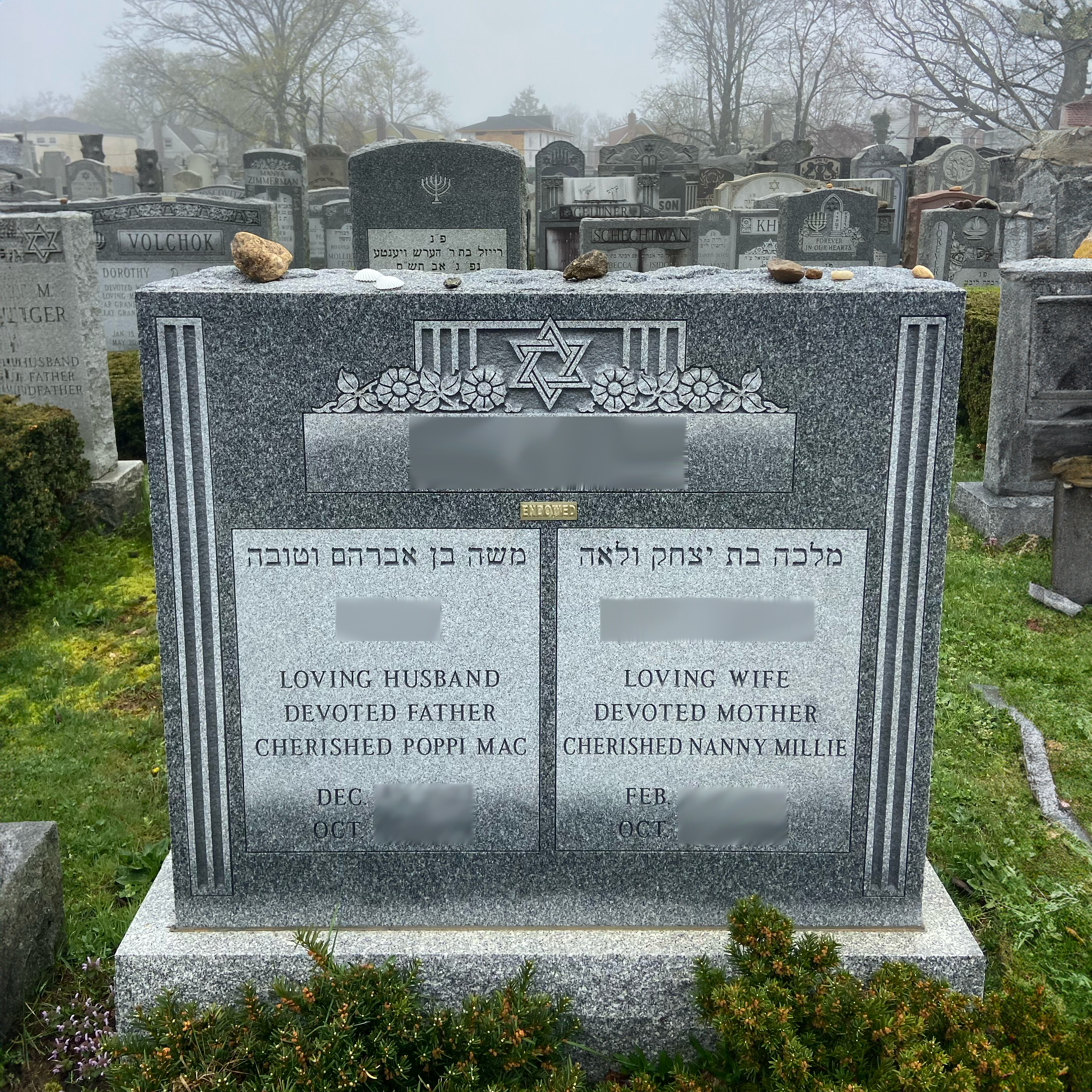 Upright double granite monument with personalized engraving, decorative carving, and religious detail.