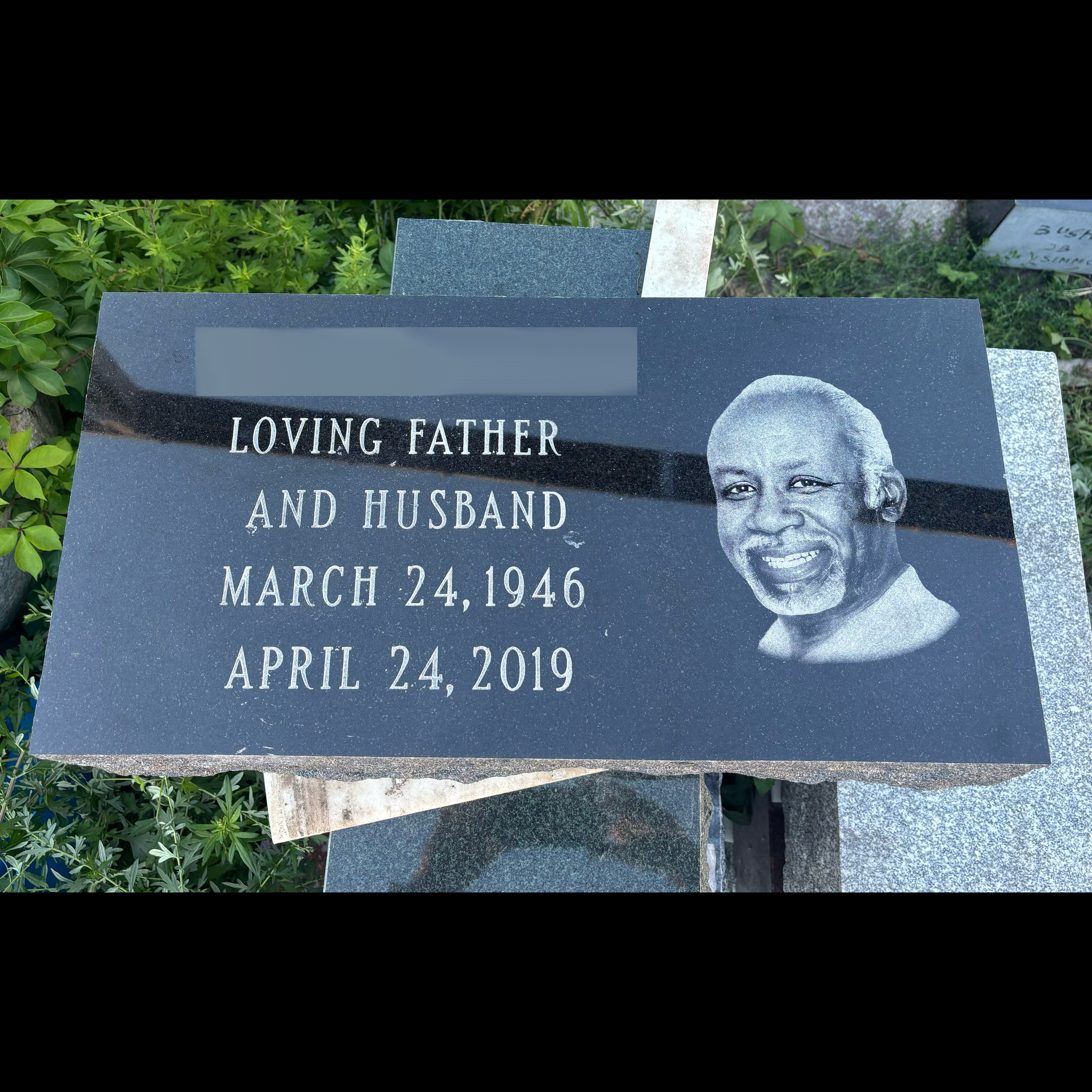 Low-profile flat granite monument showing custom decorative and engraving options with etching of an individual's face for tribute.