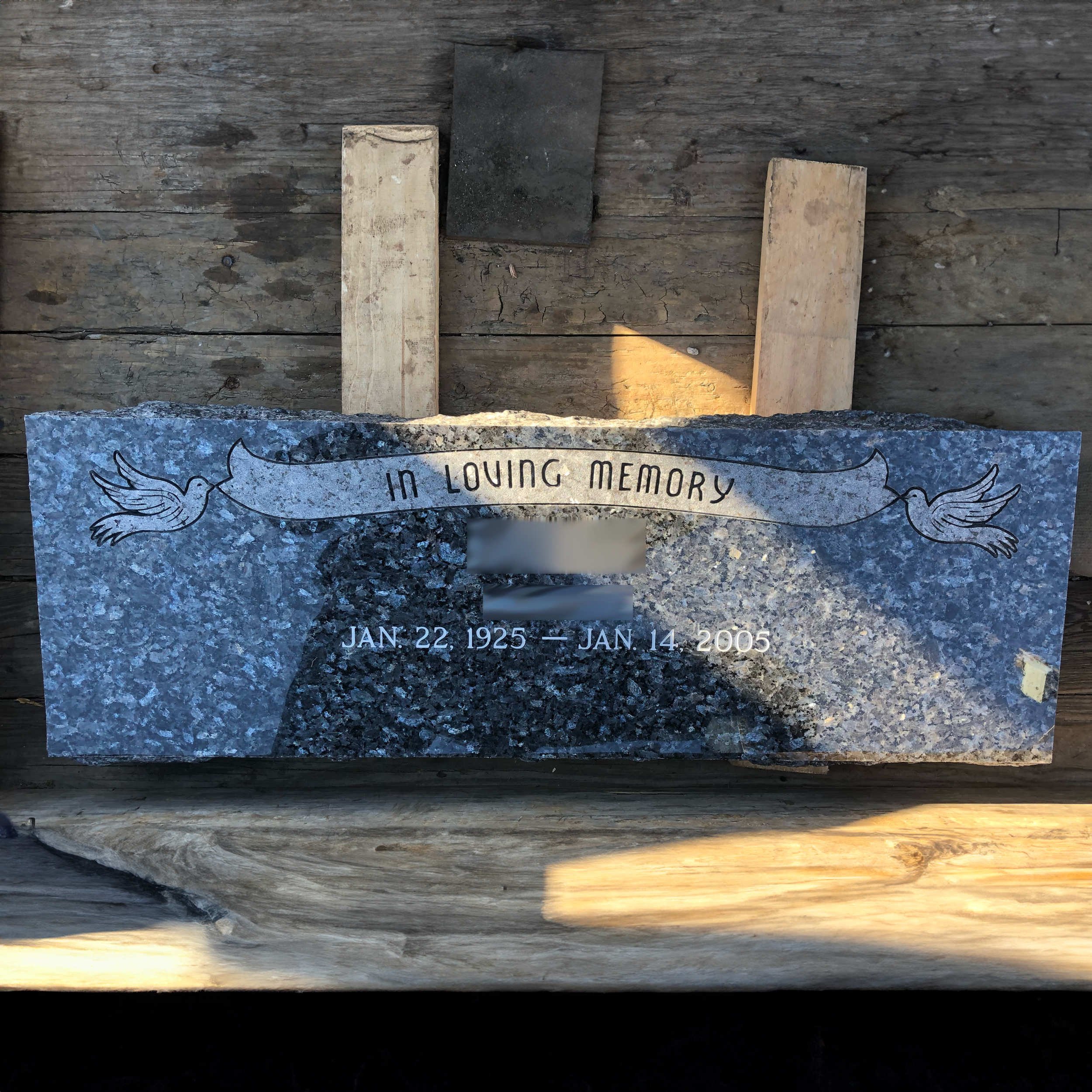 Low-profile flat granite monument showing custom decorative and engraving options.