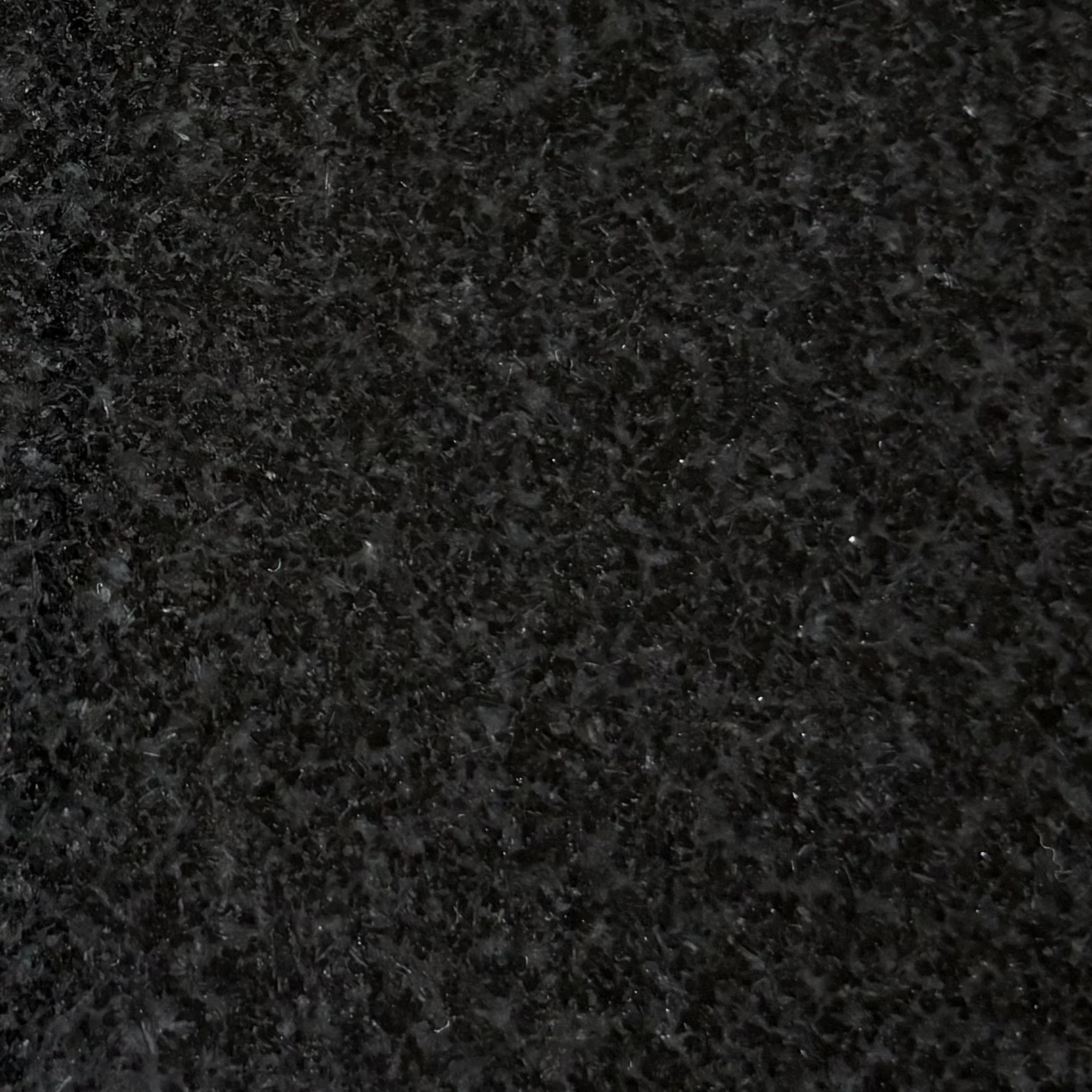 Close-up view of Jet Black, black granite surface with a textured, speckled pattern.