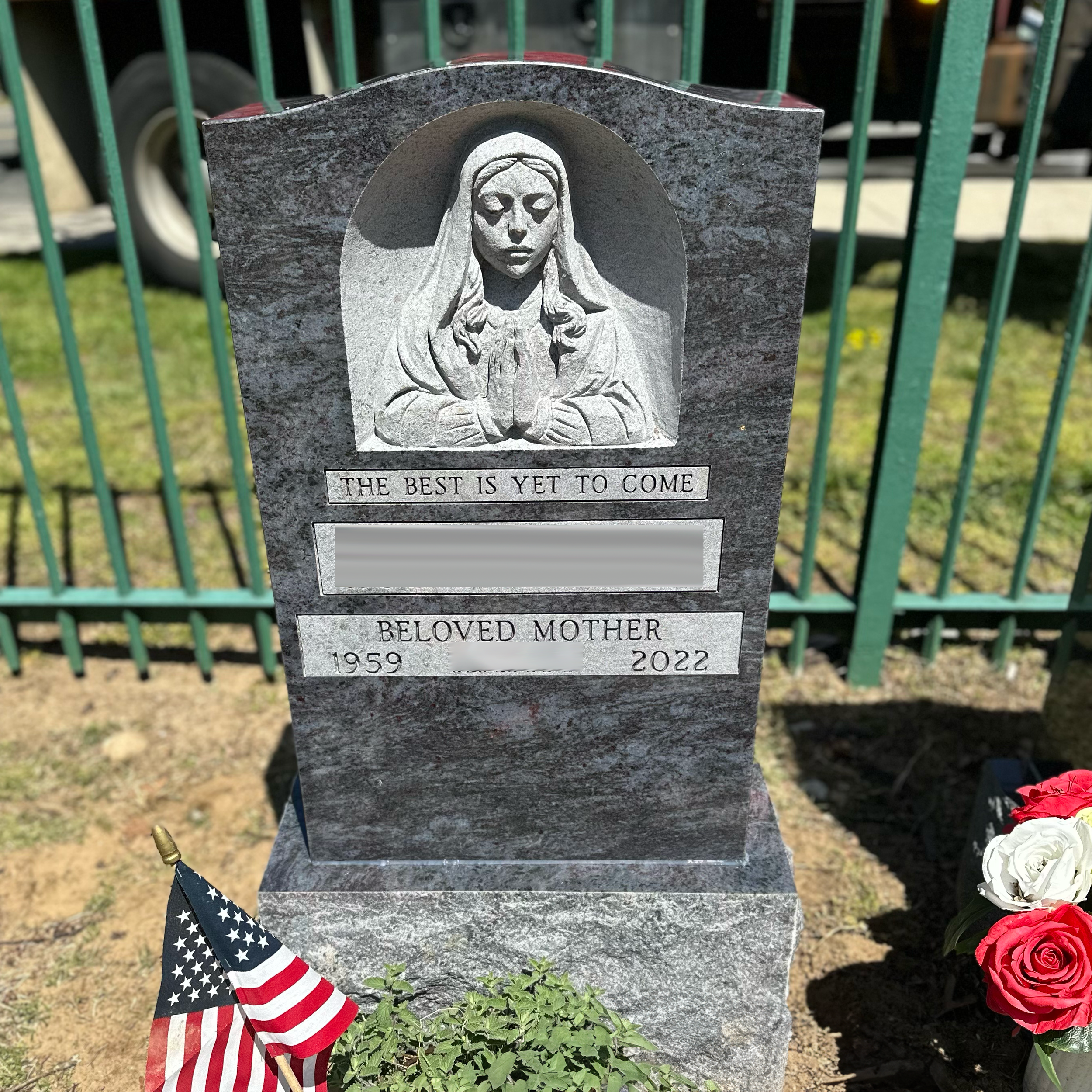 Upright granite monument with personalized engraving, decorative carving, and beautiful religious detail.