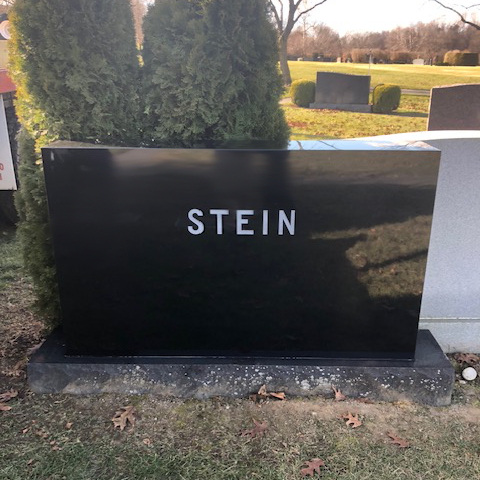 Custom upright family memorial made of granite with engraved text.