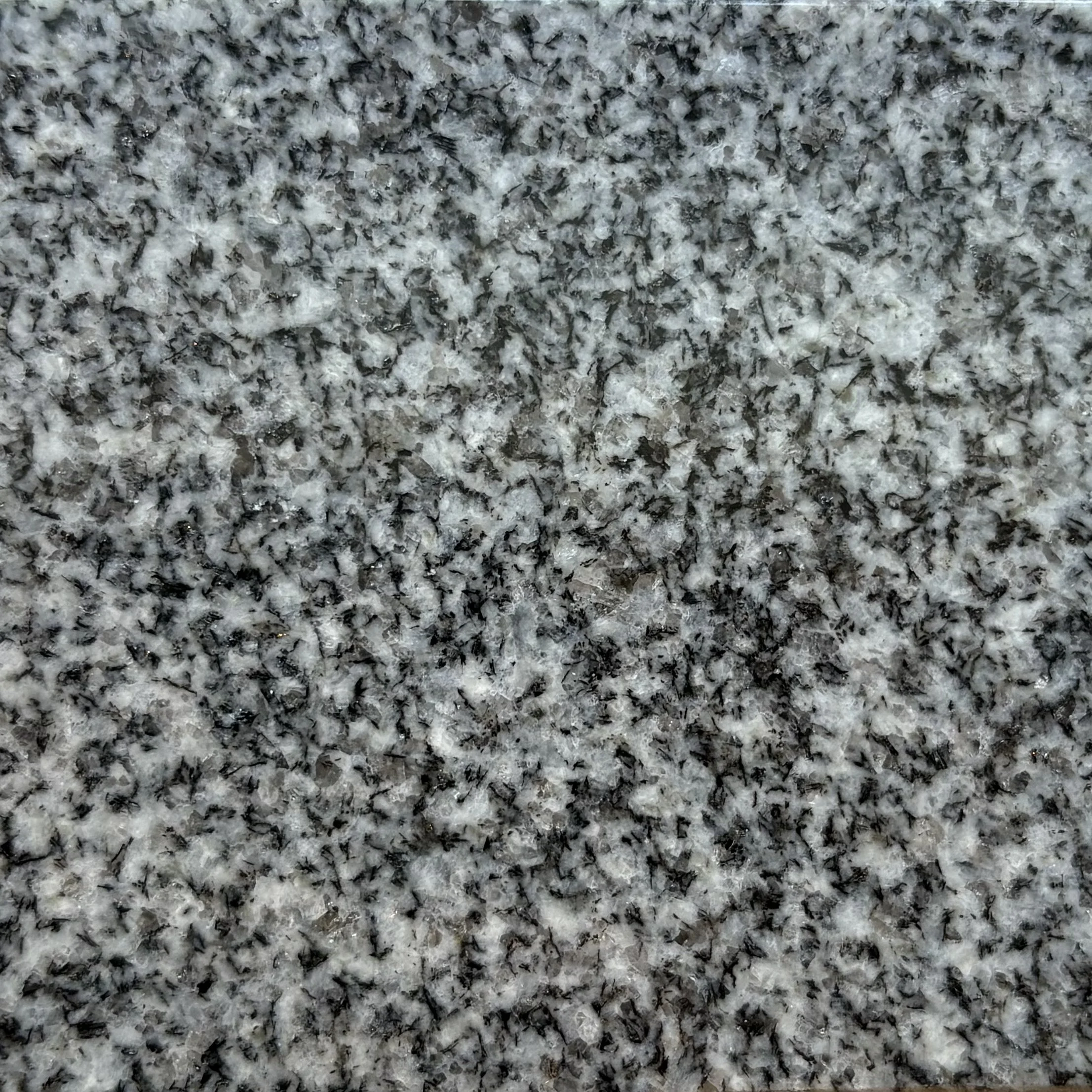 Close-up of Barre Grey, a speckled gray and black granite.