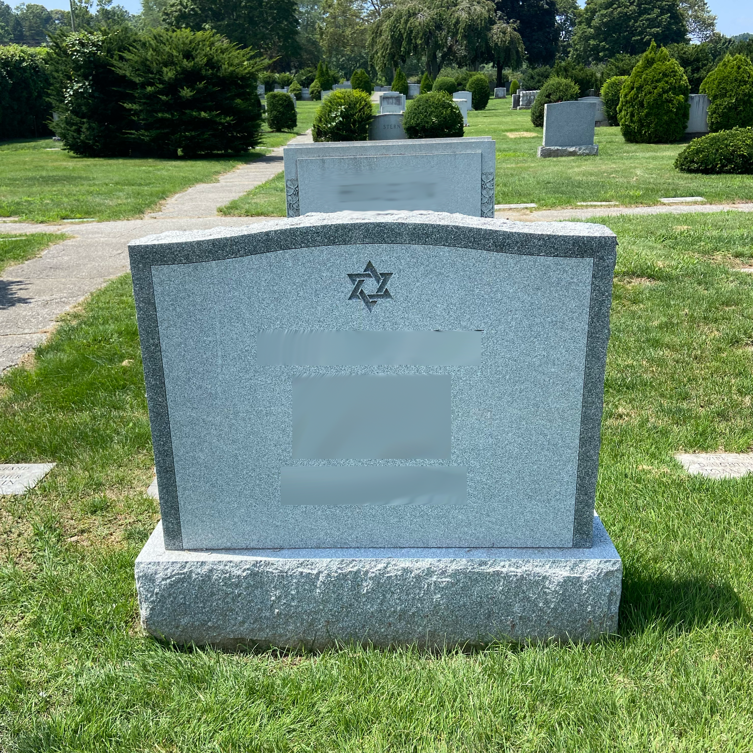 Custom upright family memorial made of granite with engraved text.