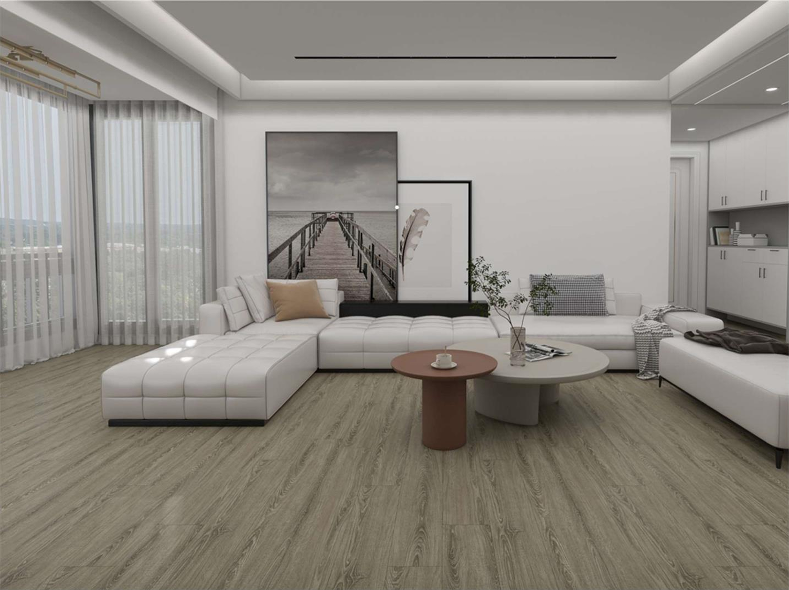 Modern living room with white sectional sofa, beige and gray pillows, two round coffee tables with a small plant and magazines, wall art of a pier over water, large windows with sheer curtains, light wood flooring, built-in white cabinets.