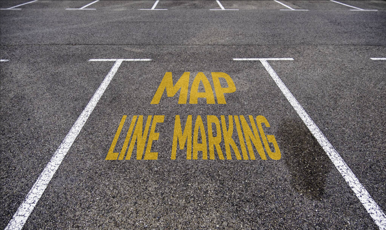 Parking lot with white parking lines and yellow text on the asphalt that says 'MAP LINE MARKING'.