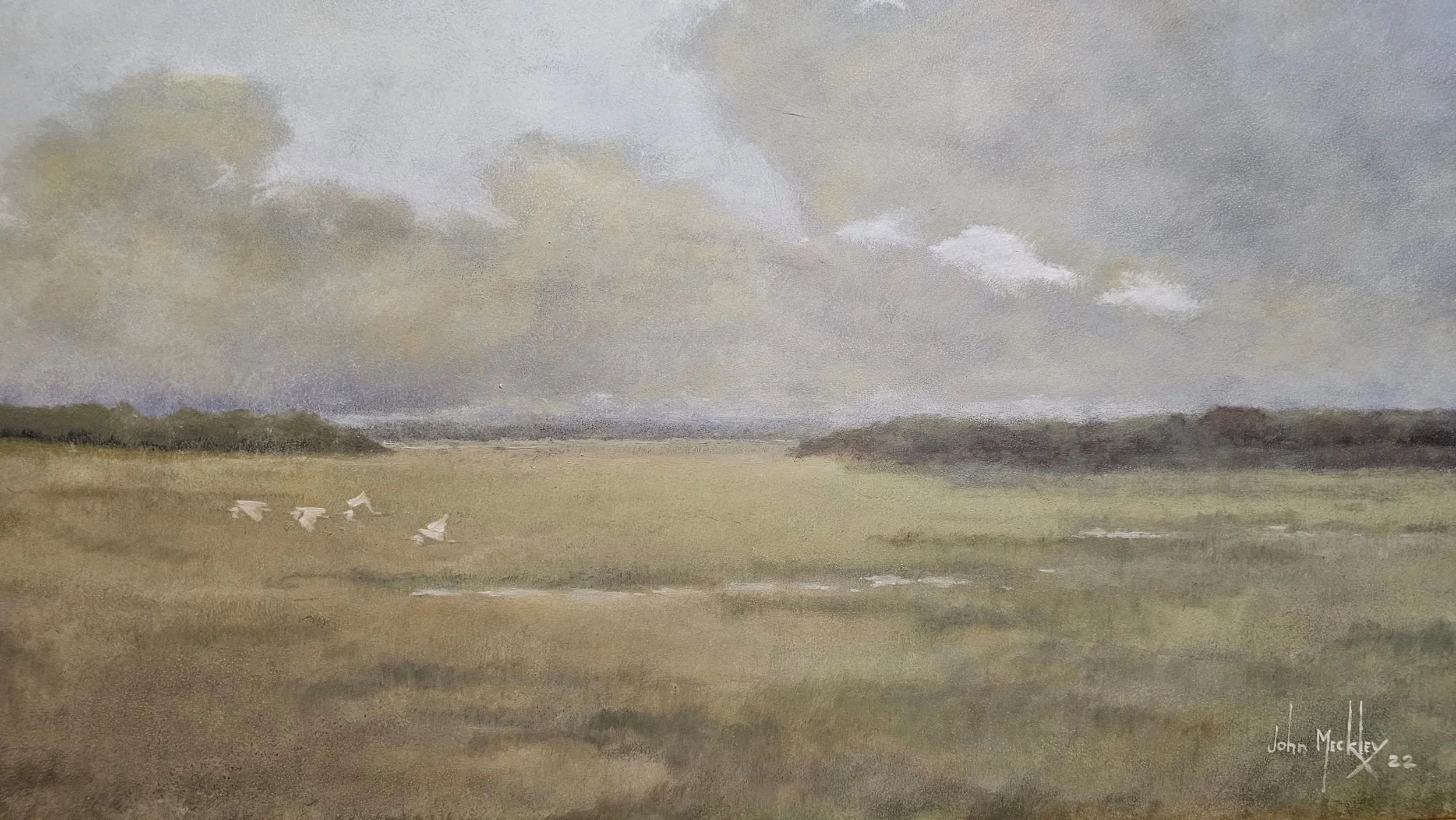 A watercolor painting of a landscape featuring a wide open field with four white birds flying low, clouds in the sky, and distant trees on the horizon. The painting is signed "John Meckley 22" in the bottom right corner.