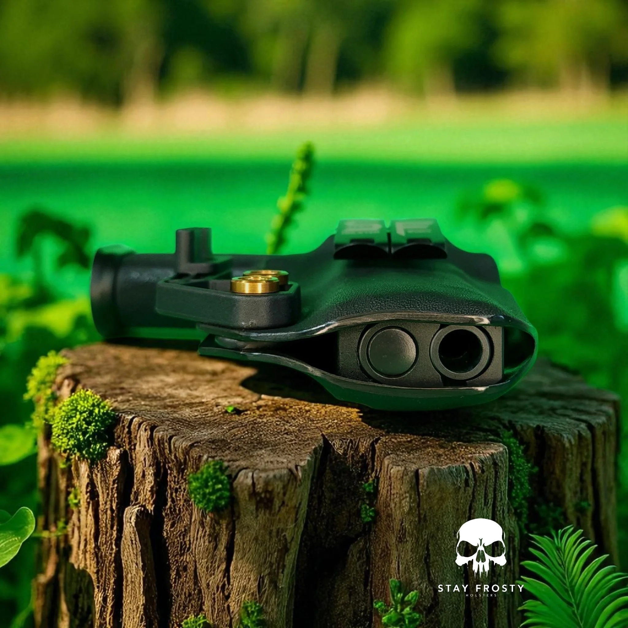 A black firearm accessory on a tree stump outdoors with green foliage and trees in the background.