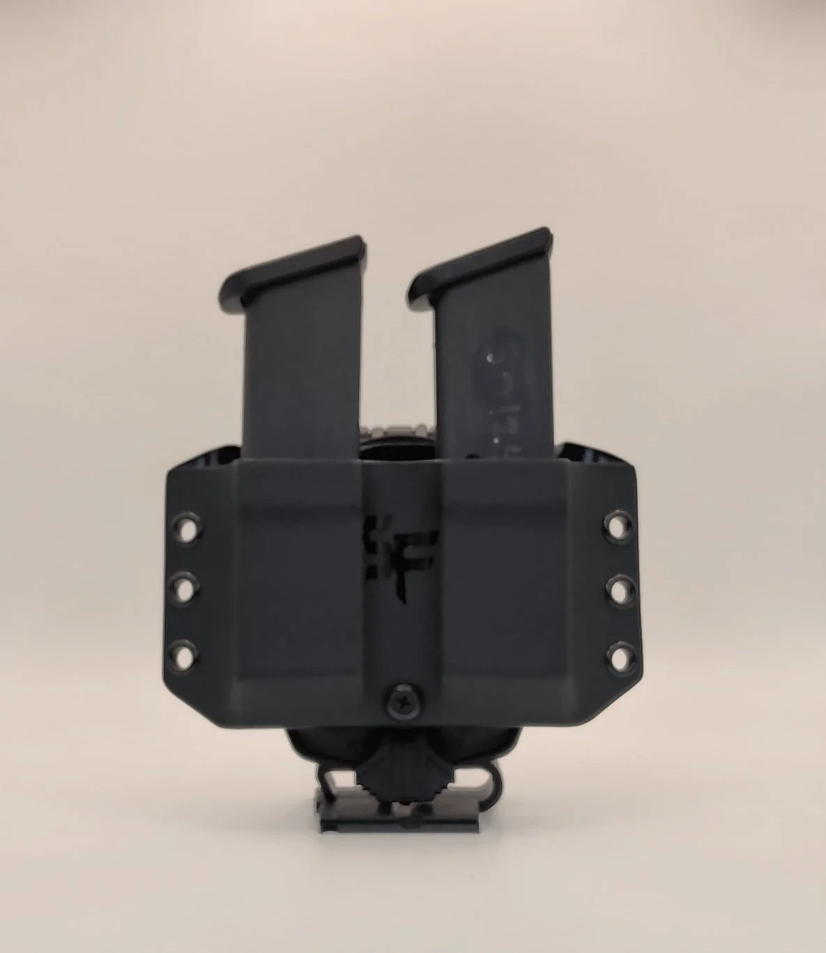 A black, rectangular device with two vertical components and multiple screws, mounted on a white background.