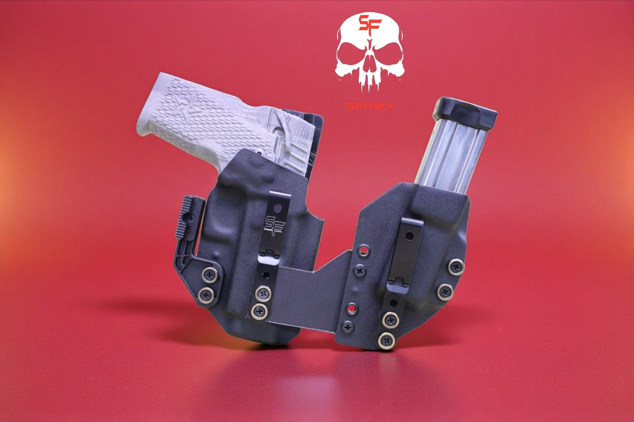 A firearm holster with a white handgun on the left side and a magazine on the right side, set against a red background with a skull logo and the text 'SF' and 'SFHWX' above and below the skull.