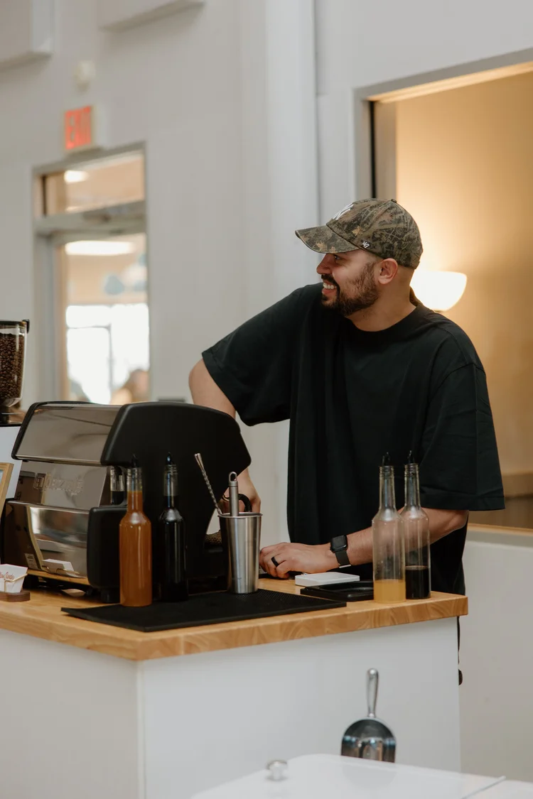 Barista making drinks behind the coffee bar at a company event
