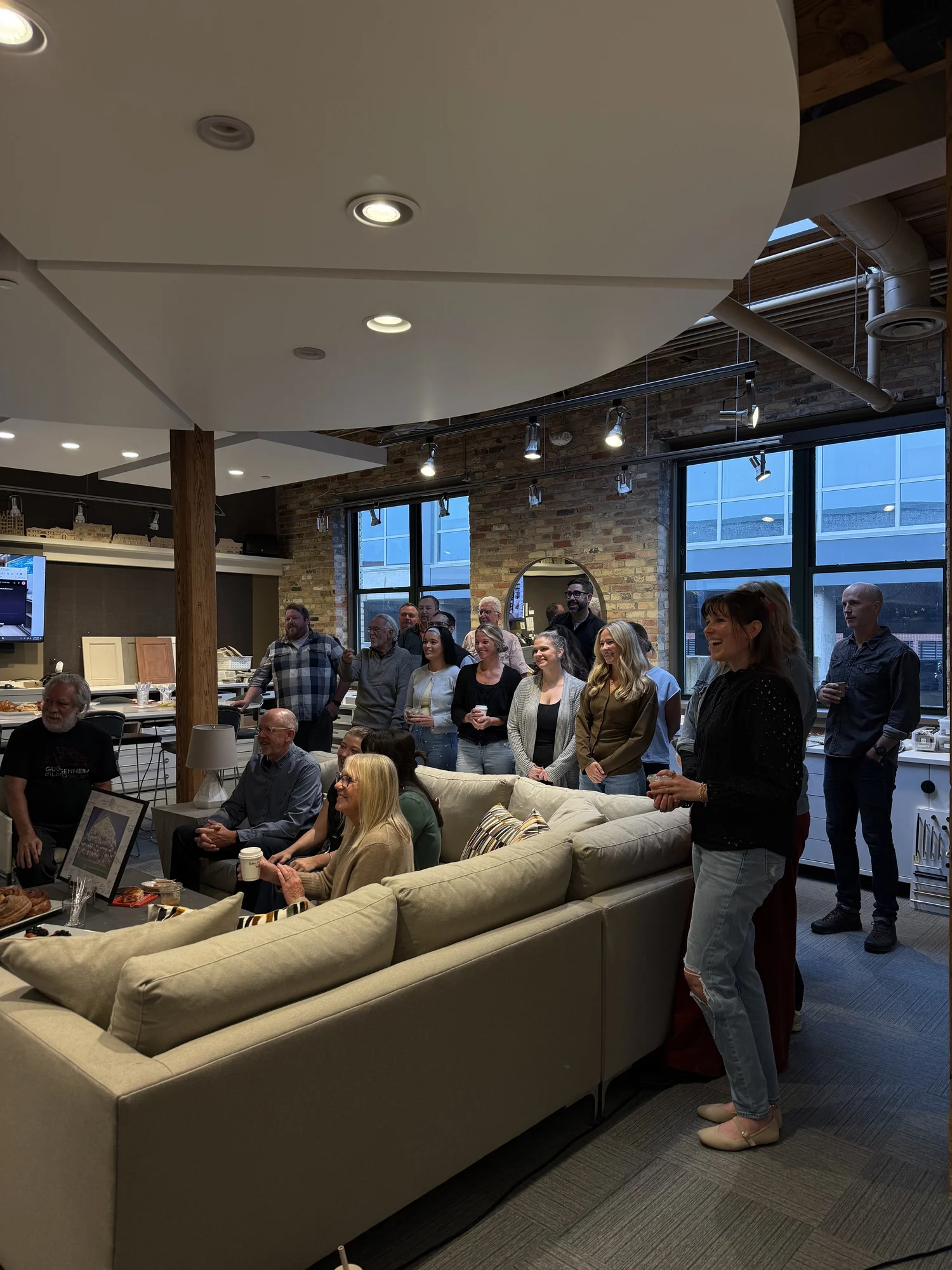 Guests gathered in a modern office lounge during a Slow Sunday coffee catering event