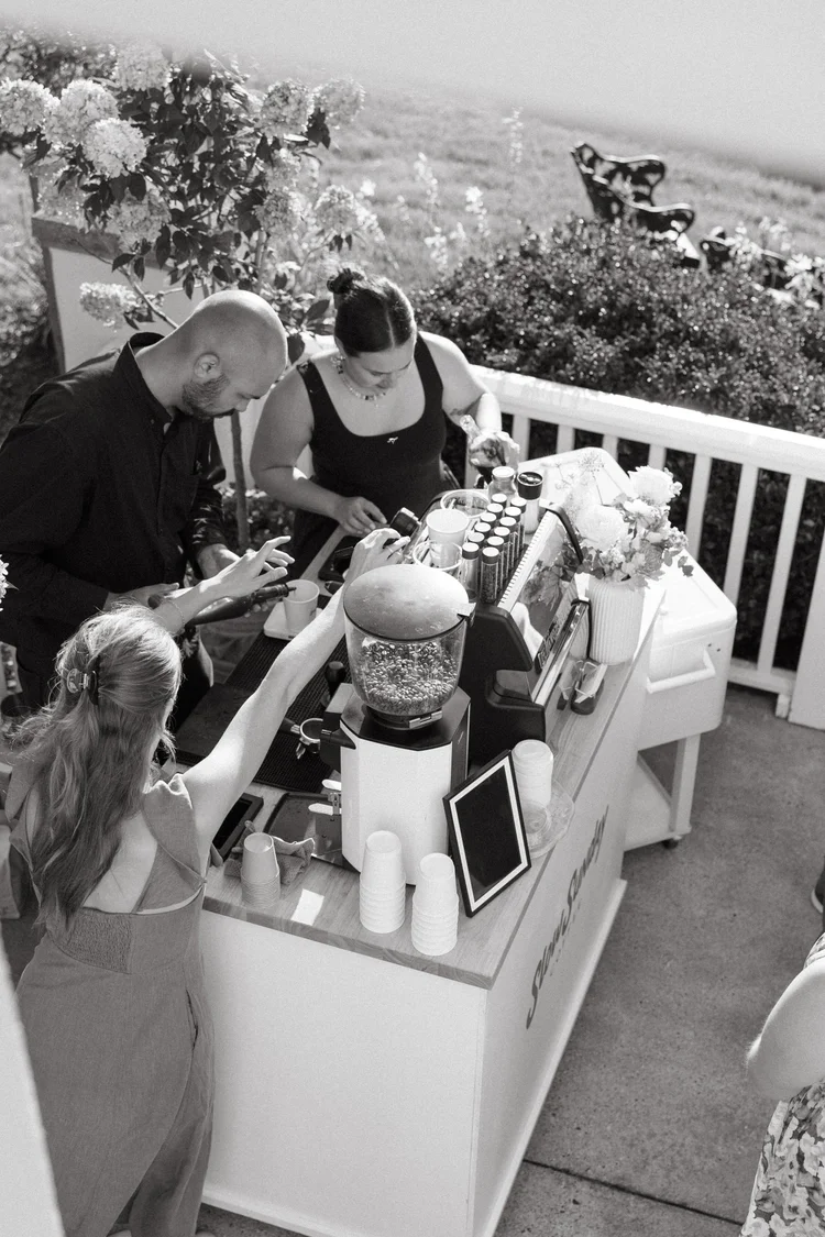 Guests crowding the coffee cart at an outdoor brand event