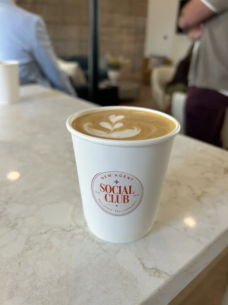 Latte in a custom branded cup on a marble counter