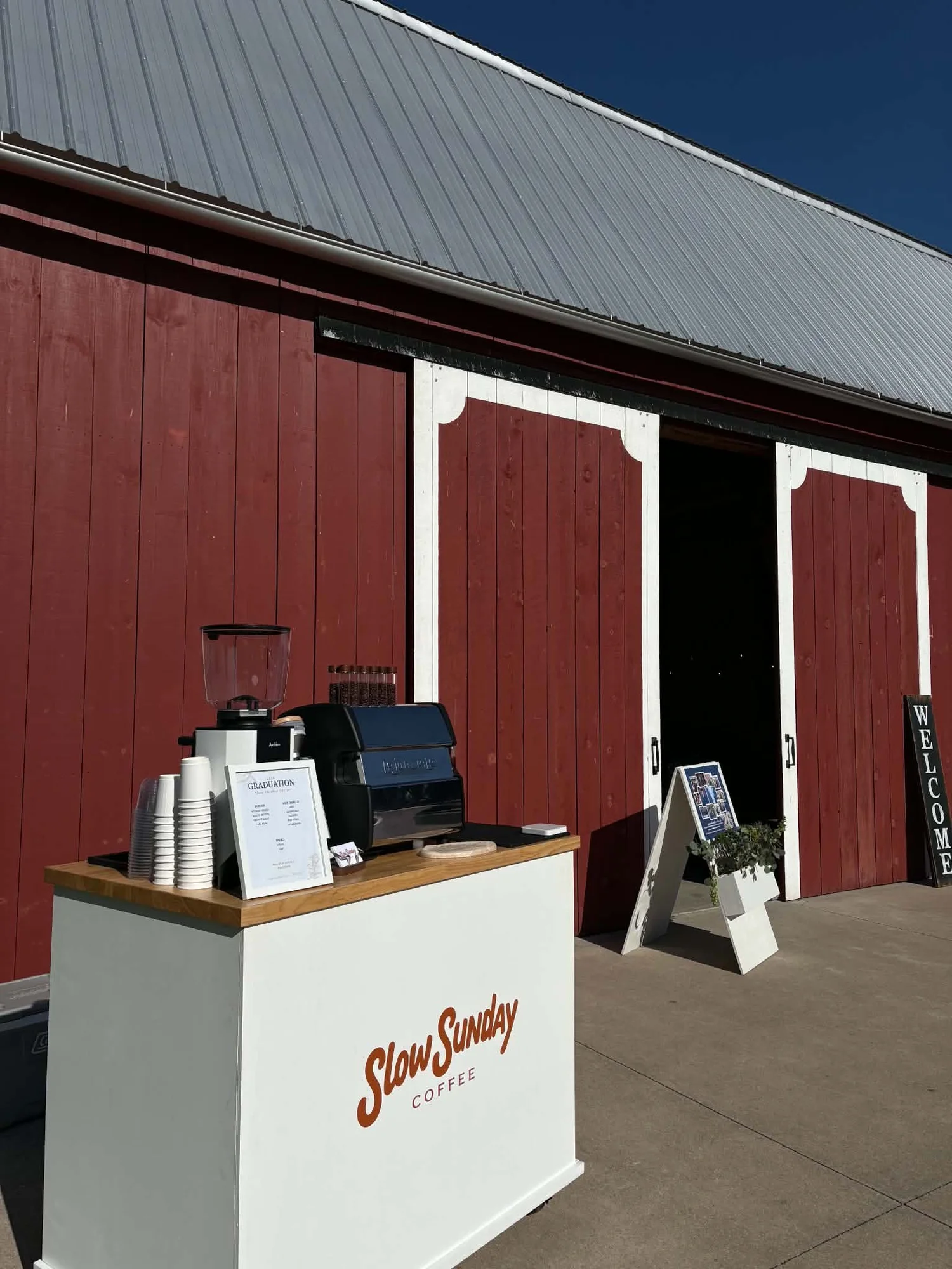 Slow Sunday coffee cart set up outside a red barn for an event