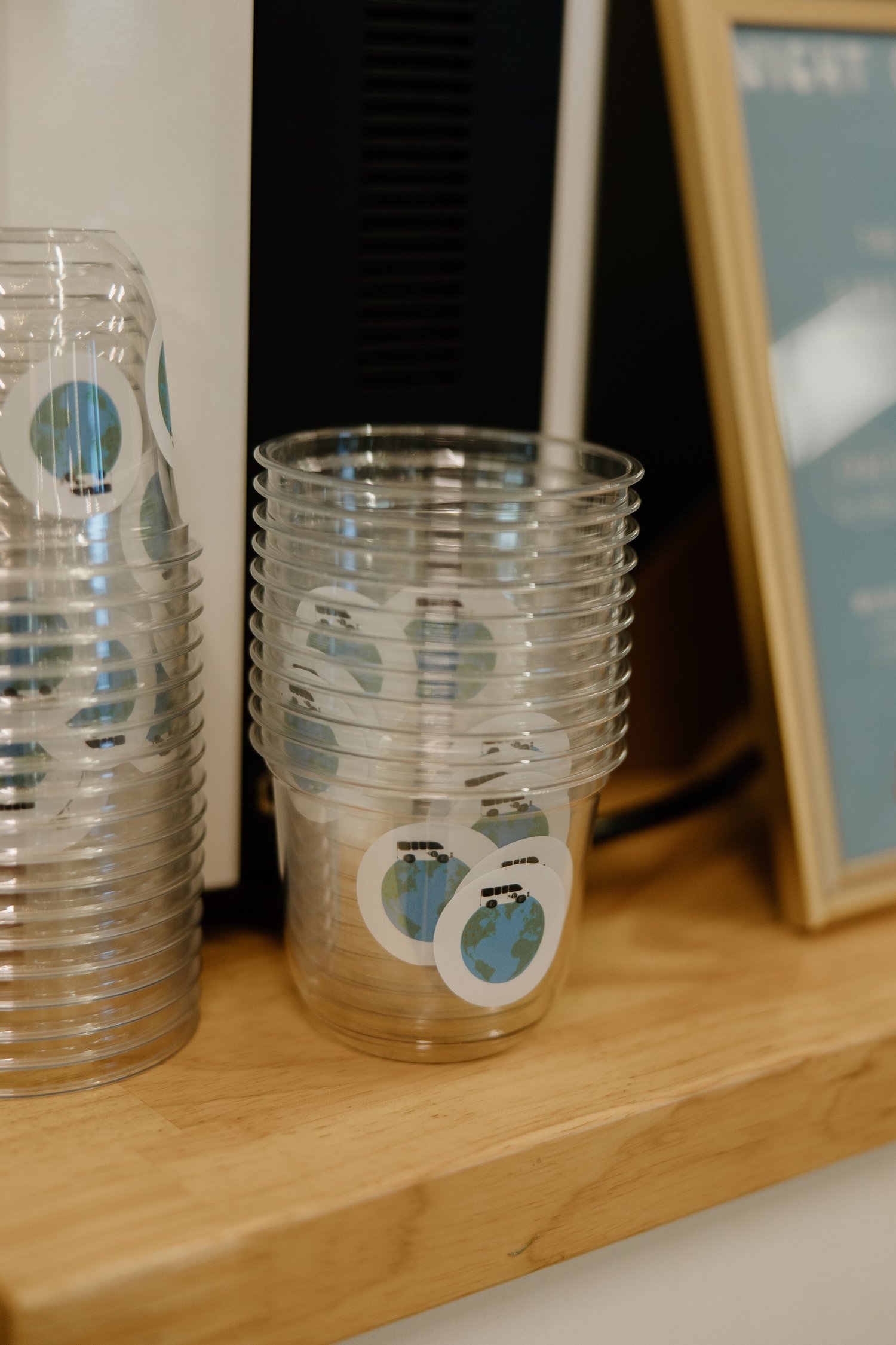 Stack of coffee cups with custom logo stickers