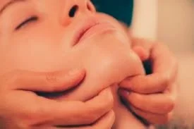 Client receiving TMJ massage for pain relief in Portland