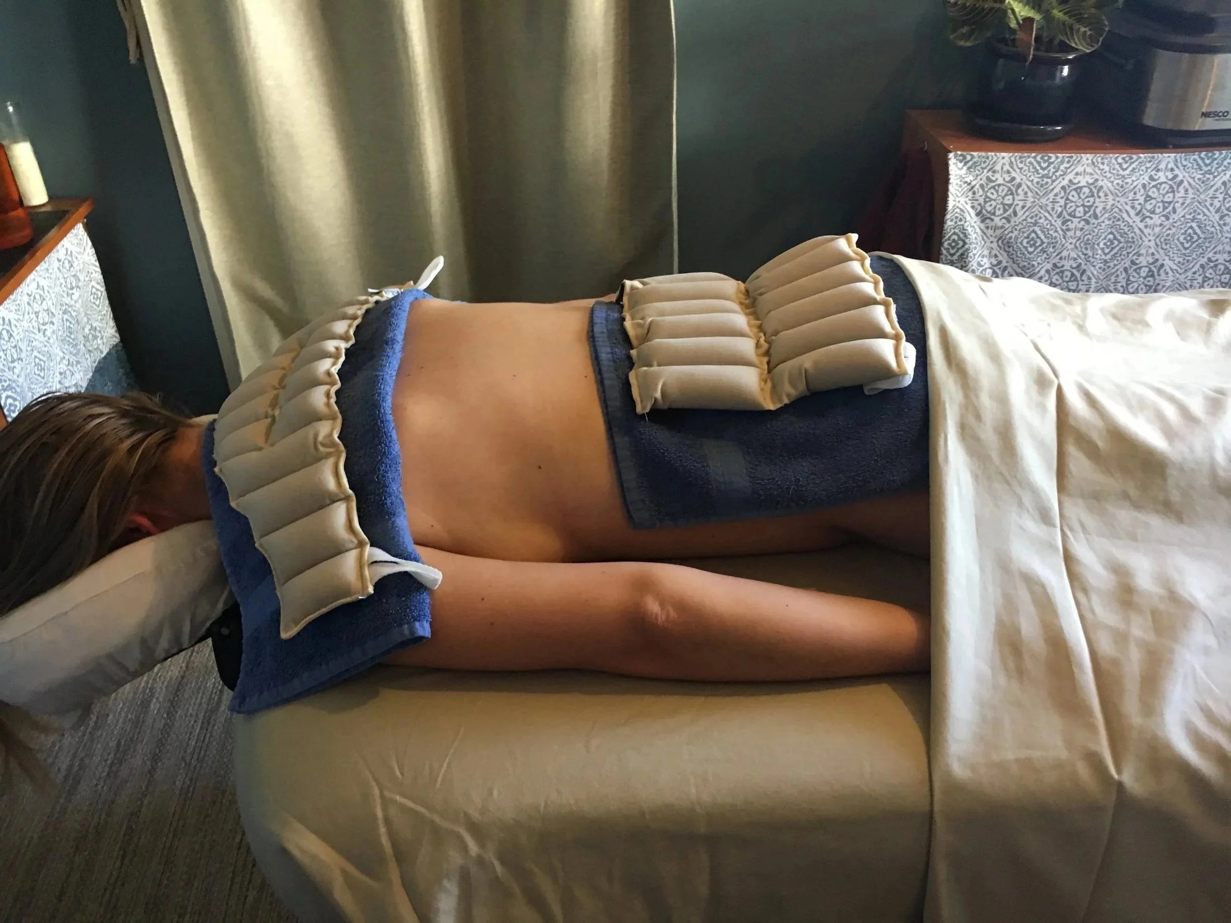 Hydrotherapy packs applied while someone is lying down.