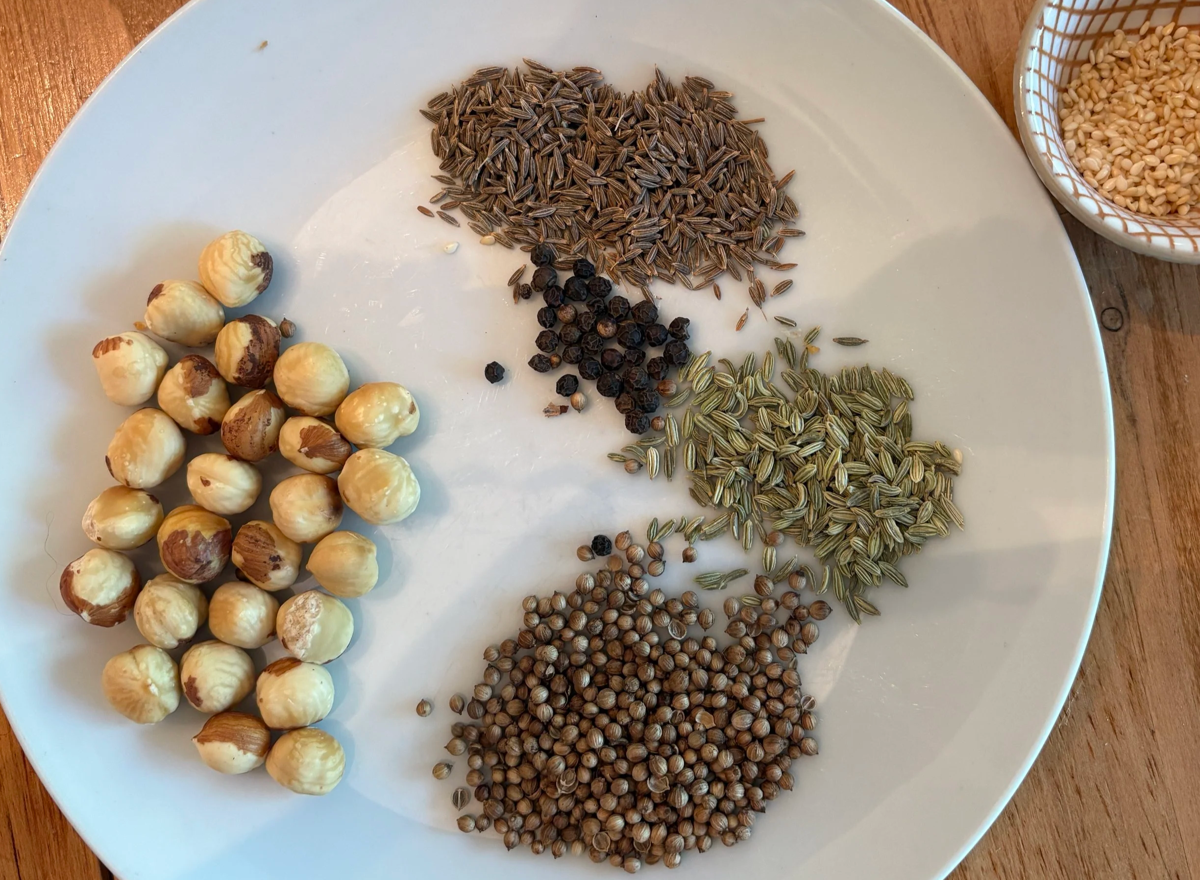Spices and nut on a white plate