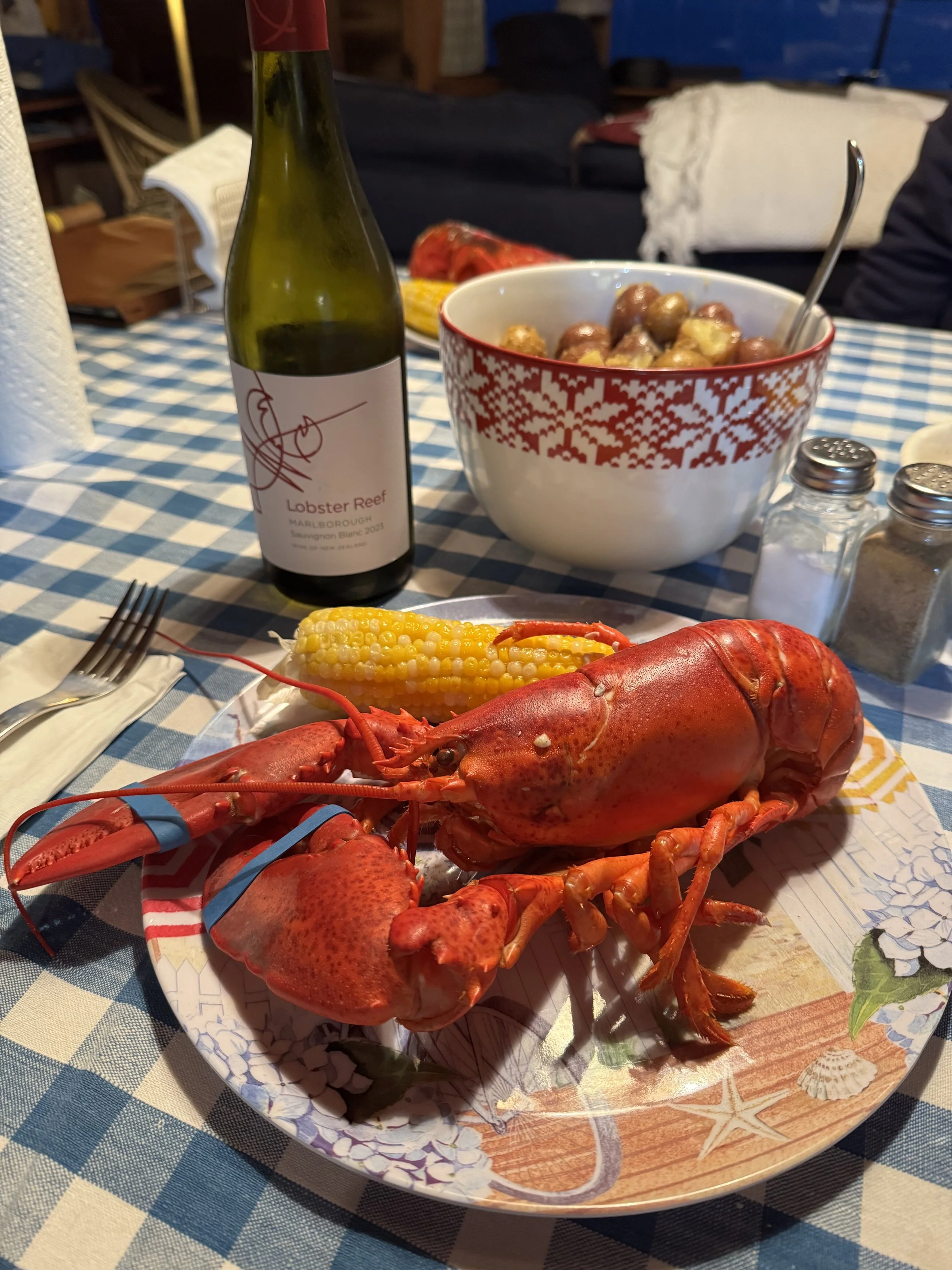 Adventure motorcycle riders enjoying a lobster dinner in Downeast Maine during a guided Northbound Moto tour