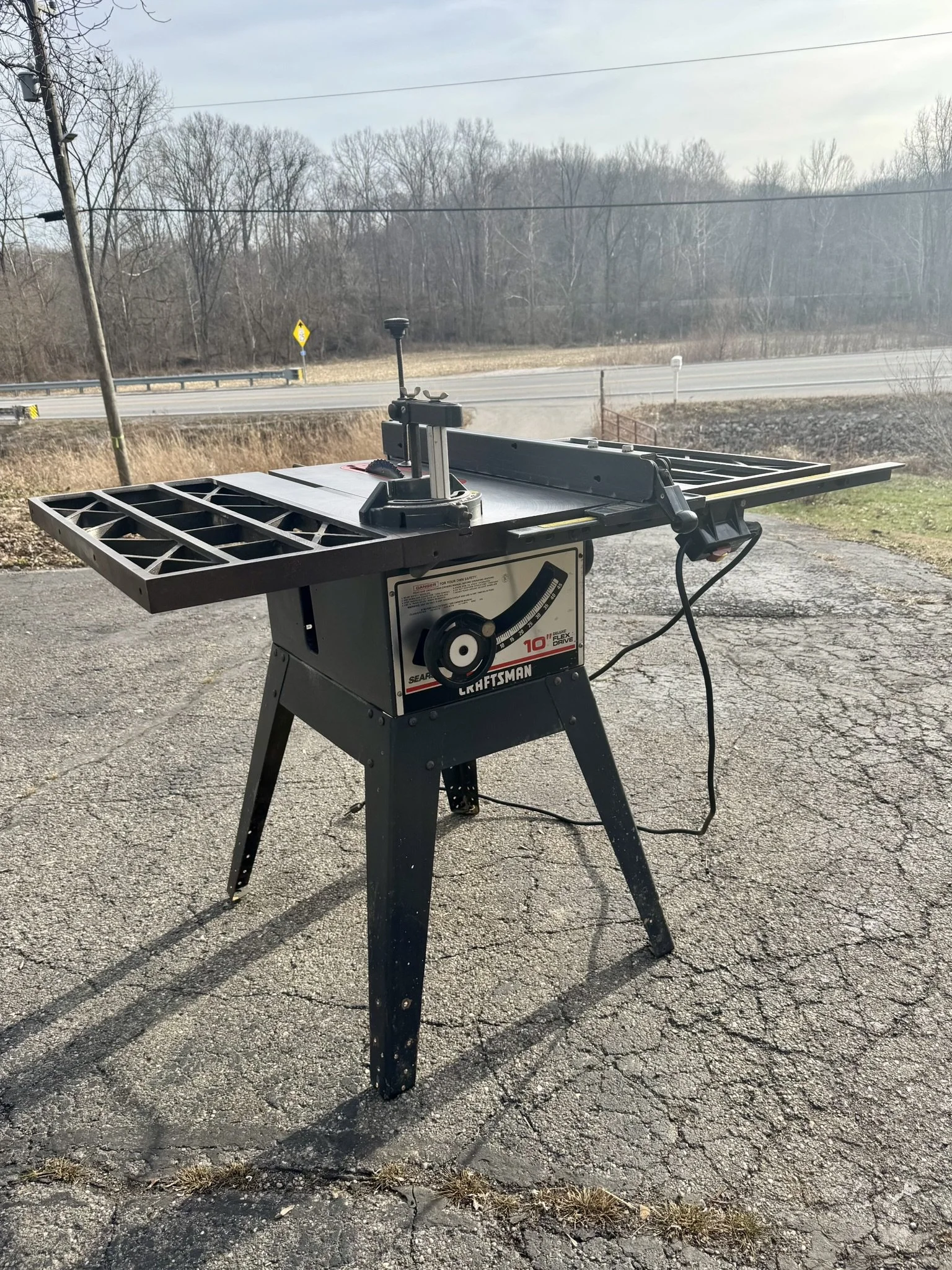 Full view of a professionally restored vintage Craftsman 113 table saw with expanded cast iron wings and a high-precision rip fence.