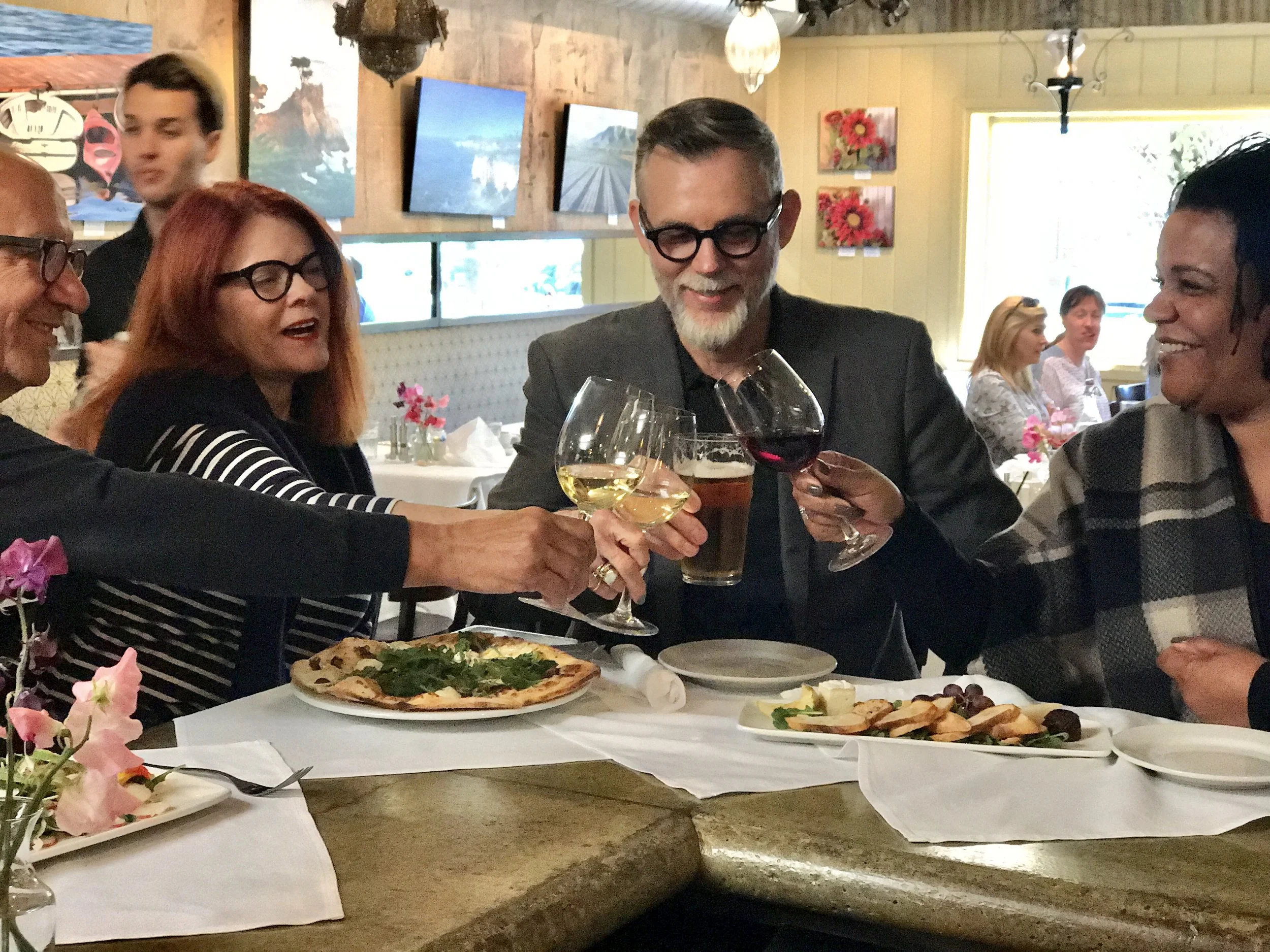 group of guests toasting at the bar
