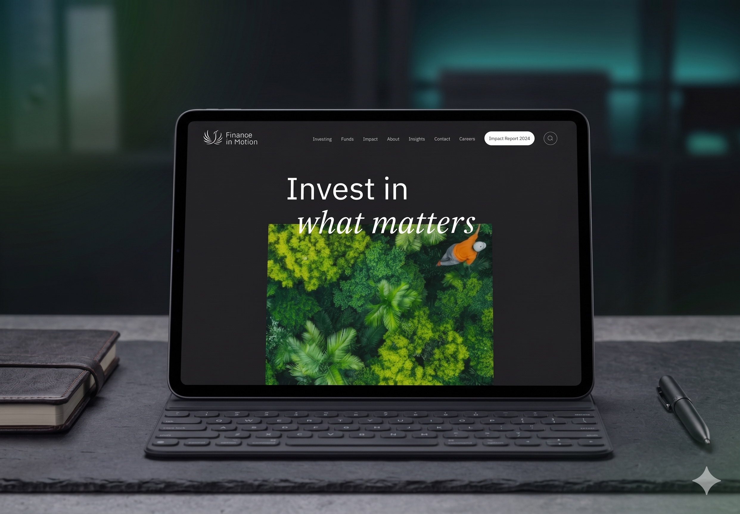 A tablet with a keyboard displaying a website titled "Finance in Motion" with the subtitle "Invest in what matters" and an image of lush green forest.