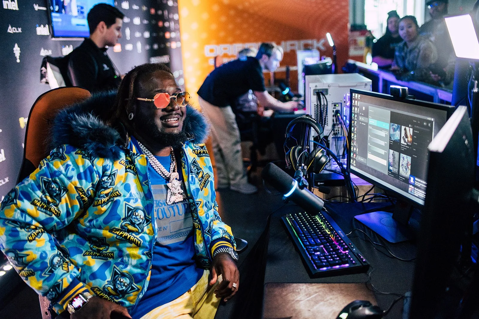 Rapper Tpain in Nappyboy Gaming Jacket and gaming at a convention