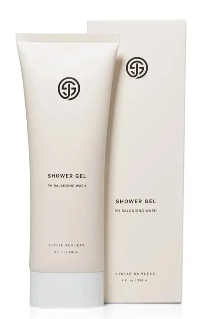 A white tube of Sjolie spray tan safe shower gel with a black circular logo and black text, placed next to its matching white box. The label reads 'Shower Gel, pH Balancing Wash, SJolie Sunless, 8 fl oz (236 ml).