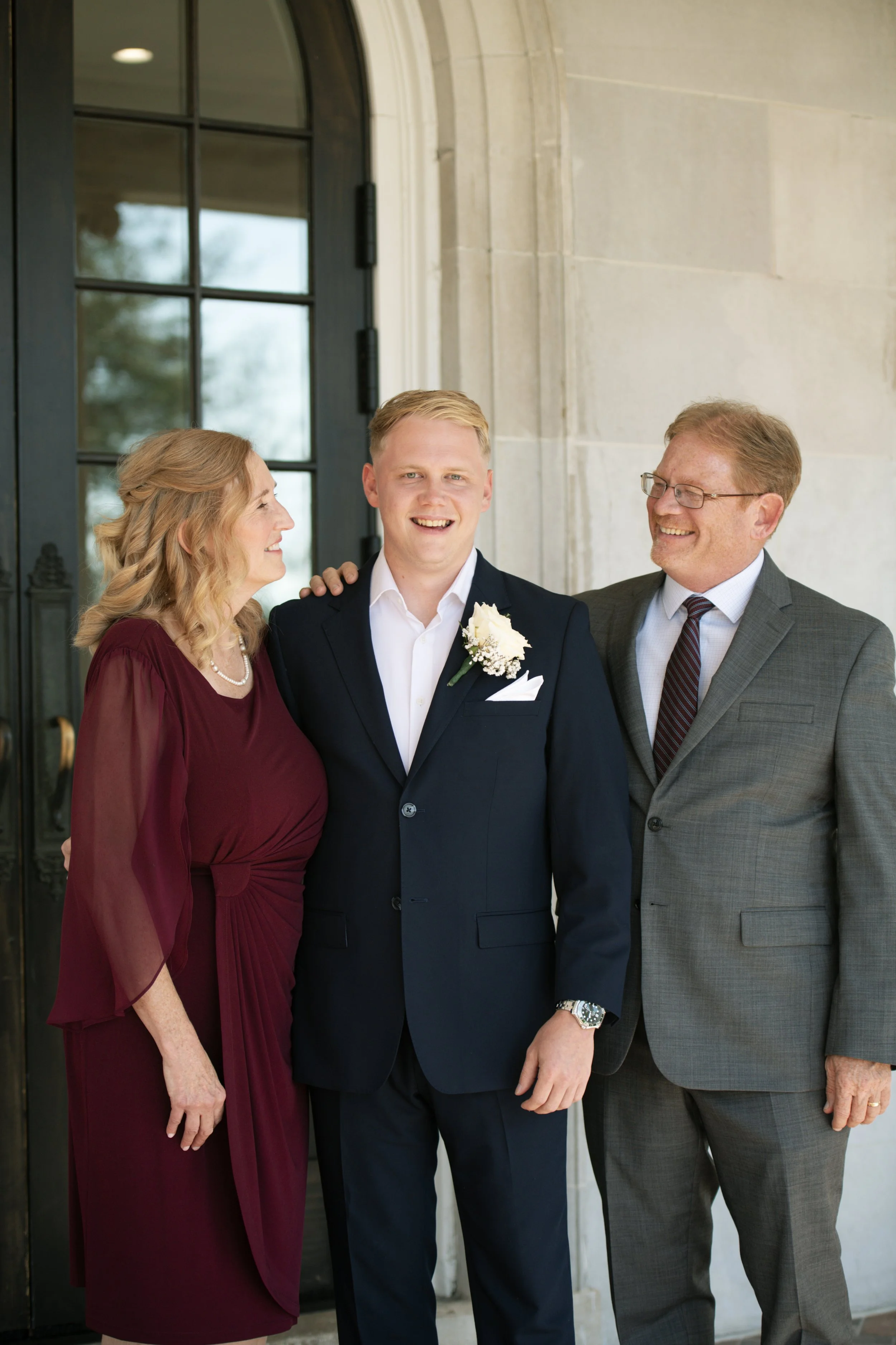 Groom posing with Mom and Dad.