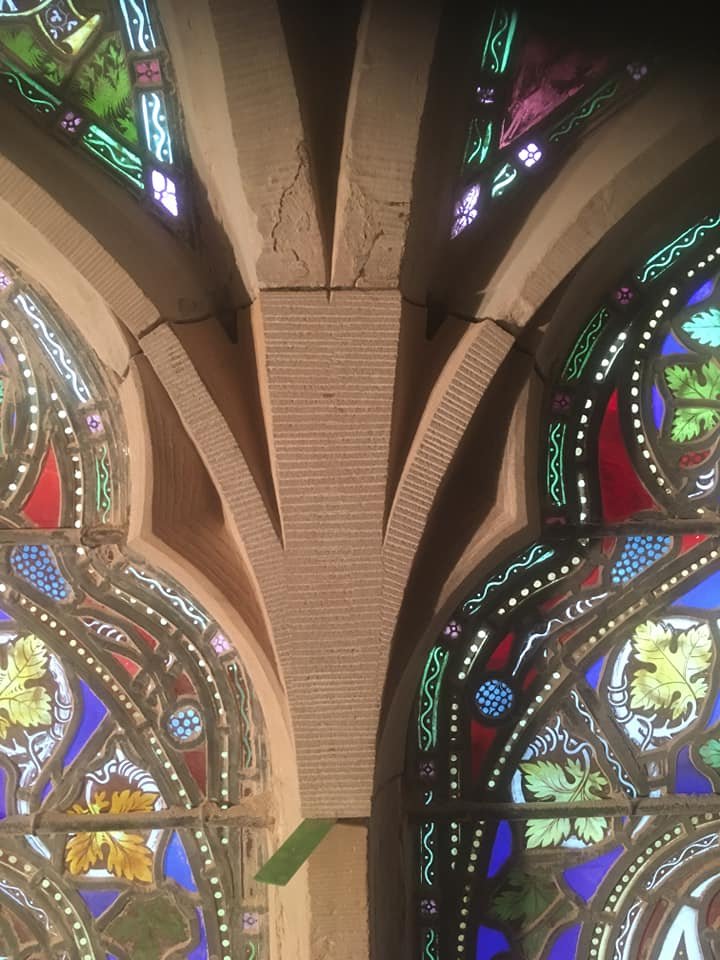 Ornamental stone repairs stain glass window  