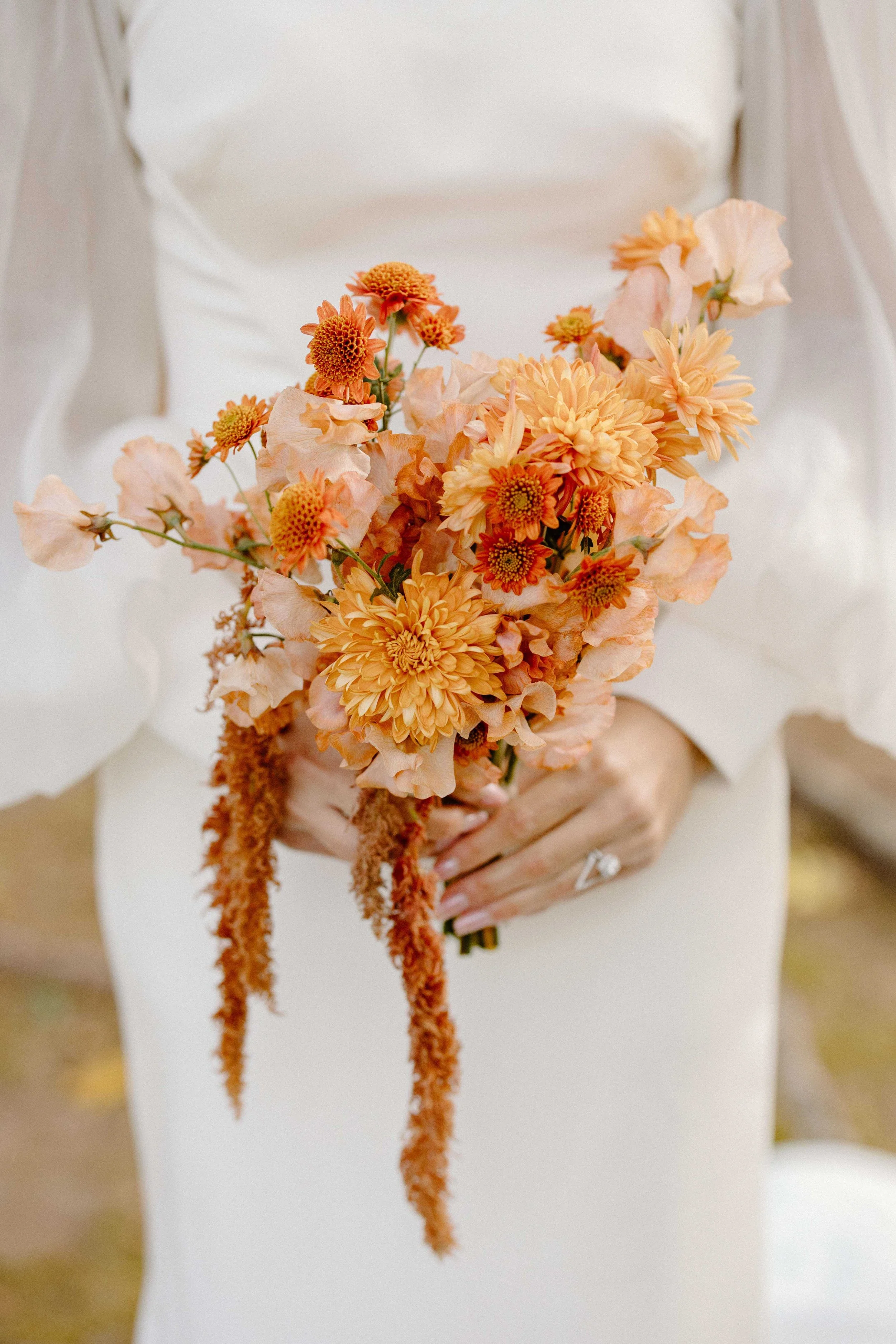 Autumn bridal bouquet with peach chrysanthemums, orange dahlias, sweet peas, and trailing amaranthus, Barn on Walnut Hill, Milkweed Floral Co