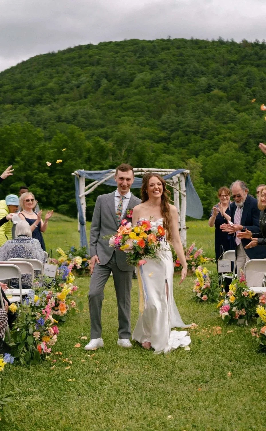 Colorful spring wedding recessional with pink, yellow, and orange aisle florals, Montague, Massachusetts, Milkweed Floral Co