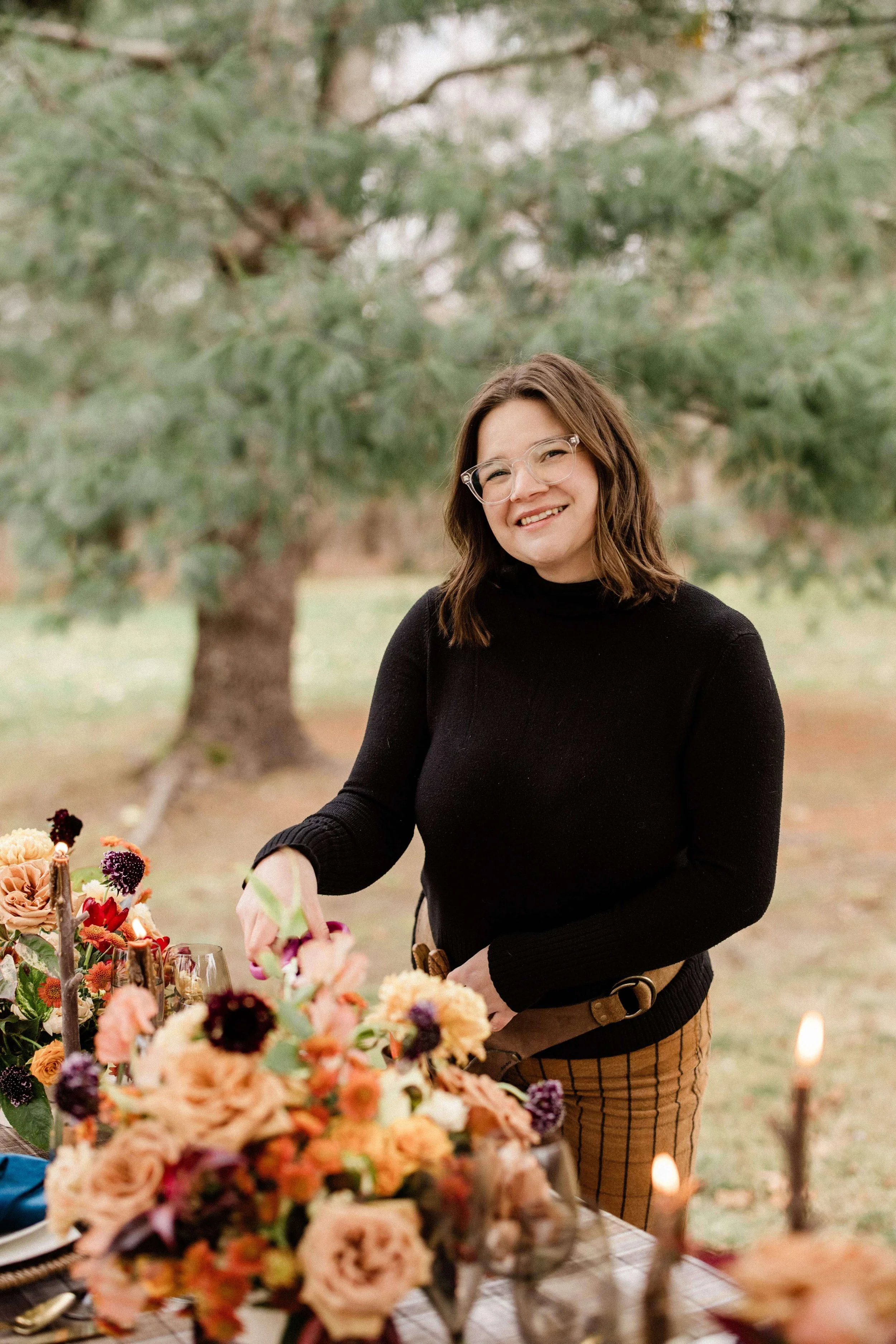 Milkweed Floral Co founder styling an autumn tablescape in Maine with peach garden roses, dahlias, and deep plum blooms