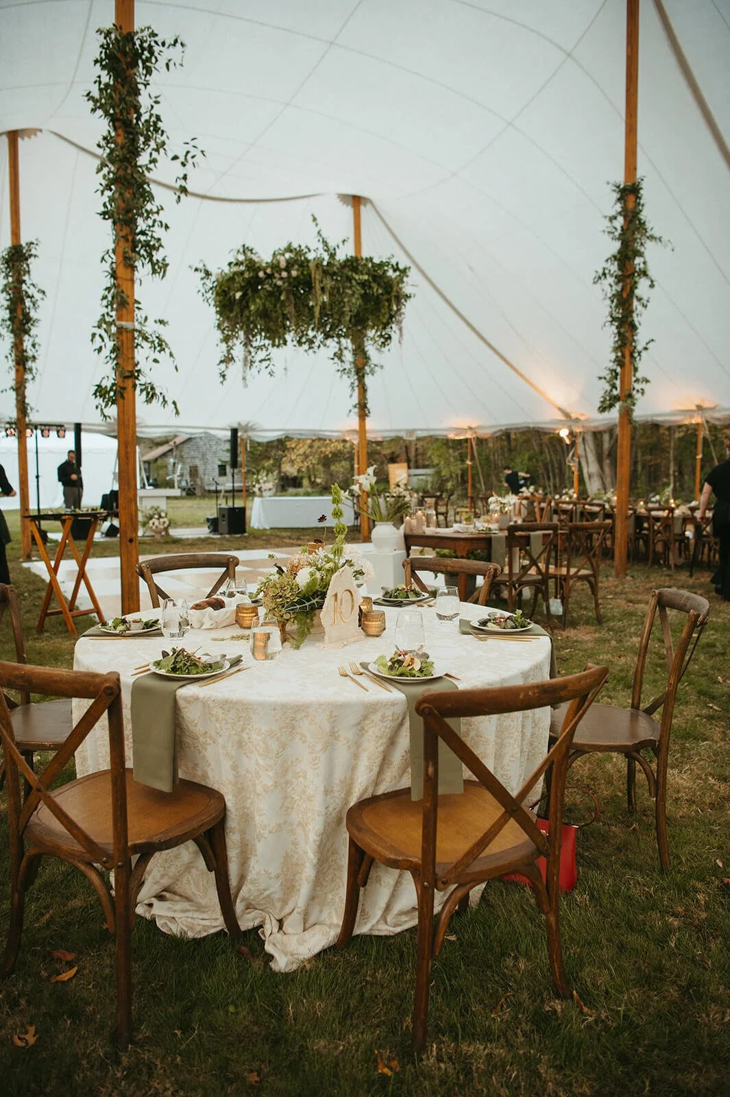 Romantic and cascading hanging installation made of greenery under event tent