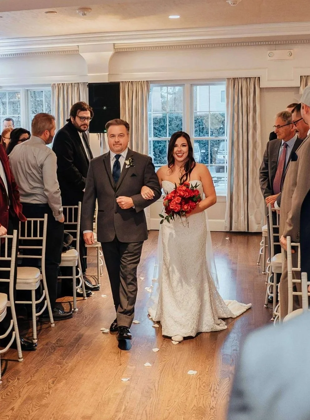 Bride walking down the aisle with her father holding a lush red bouquet at Saphire Estate, Sharon Massachusetts wedding florals by Milkweed Floral Co