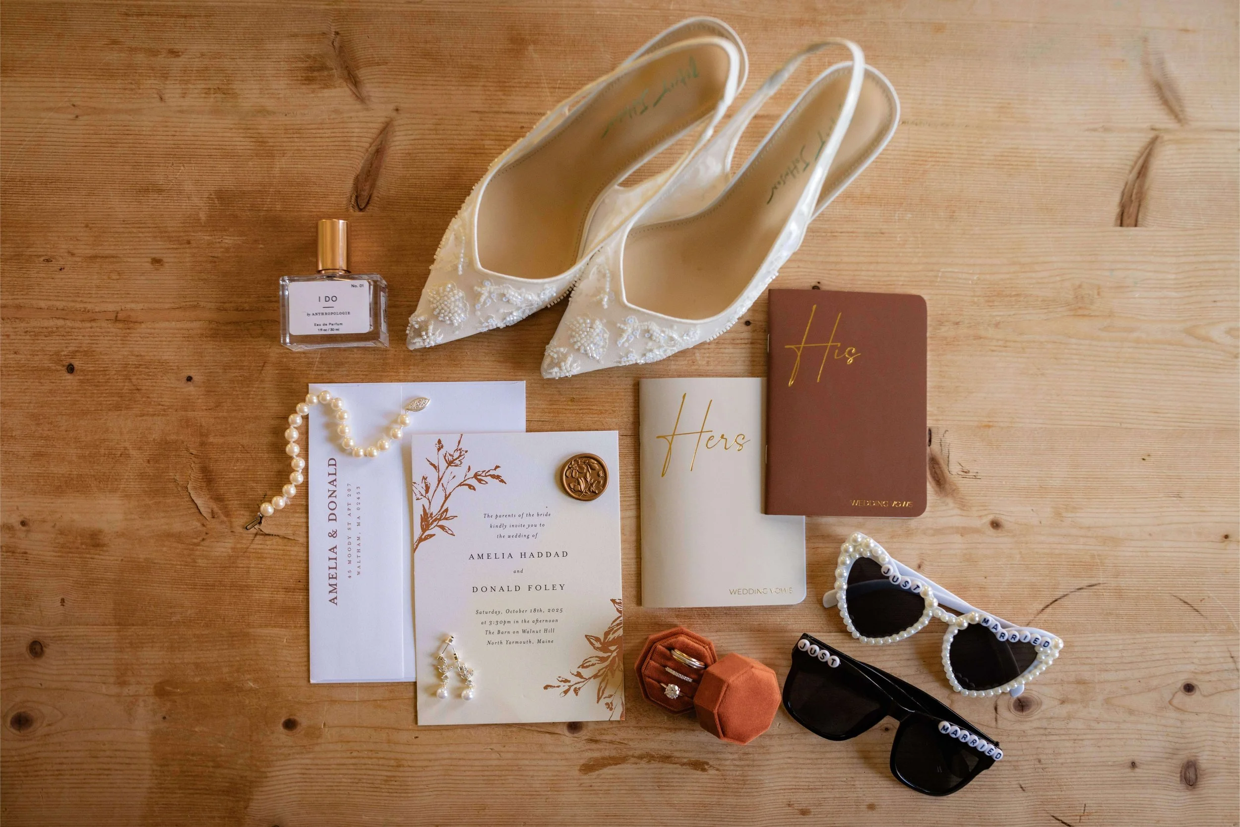Autumn wedding invitation suite flatlay with white and brown stationery, white embroidered shoes, velvet ring box, and beaded sunglasses, Barn at Walnut Hill, Maine wedding by Milkweed Floral Co