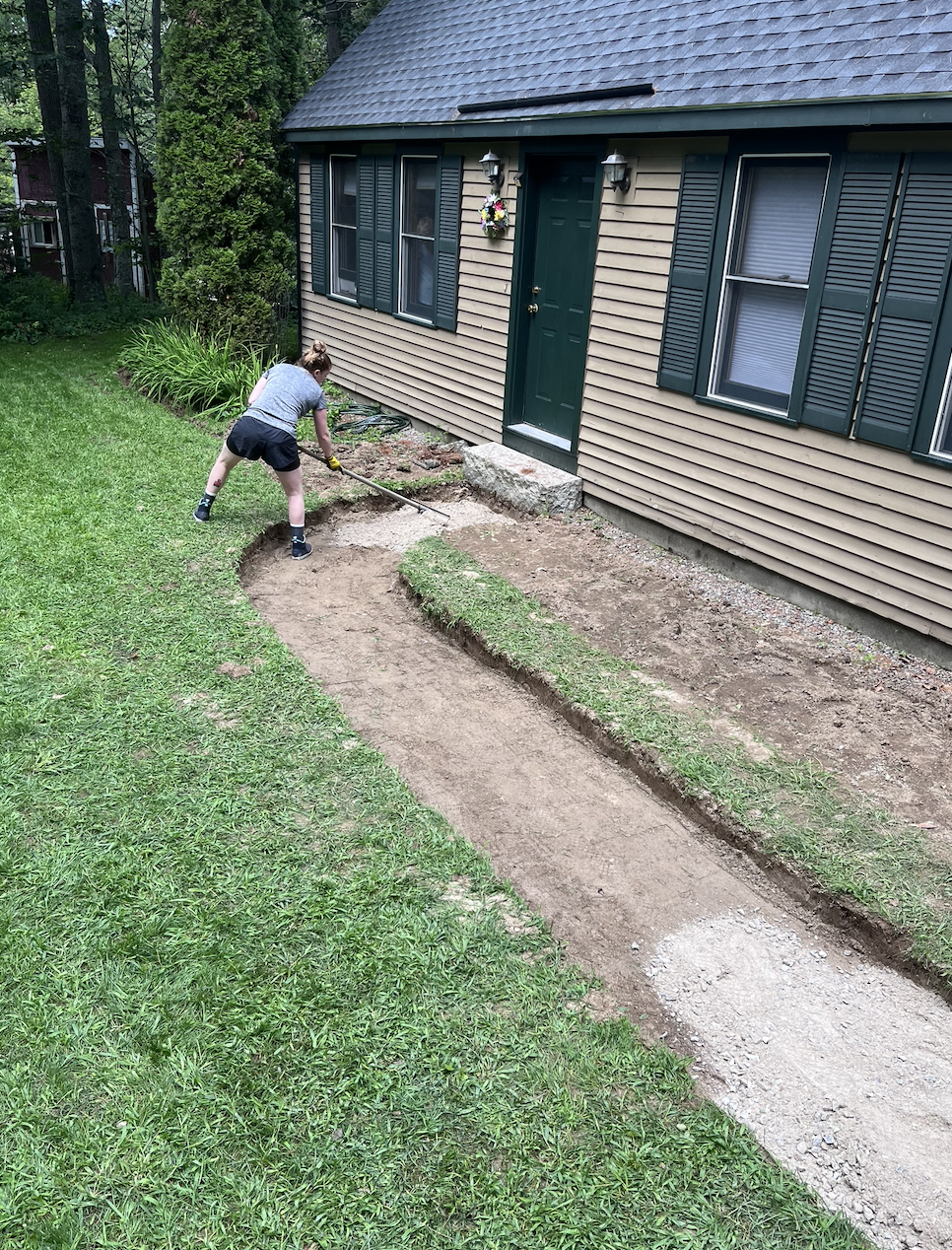 Veronica is working hard spreading the first layer of crushed stone base!