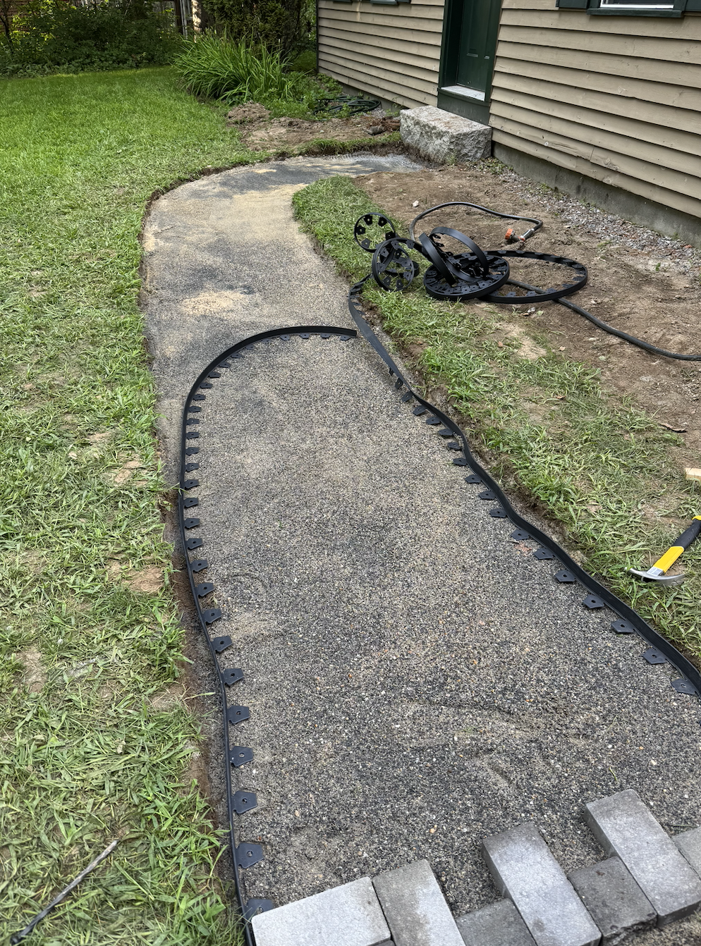 Next, we put in our flexible paver edging. 