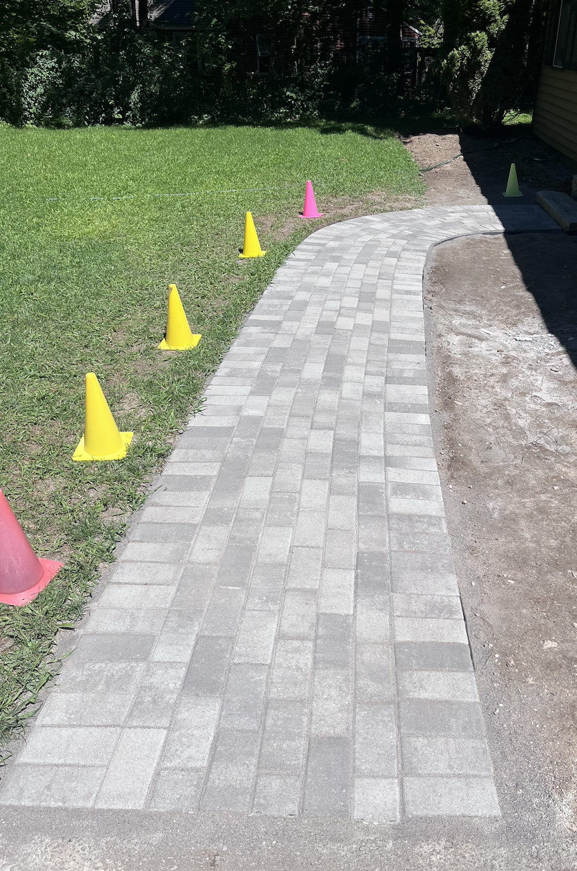 Lastly, we put down the glue (polymeric sand) locking the pavers in place.