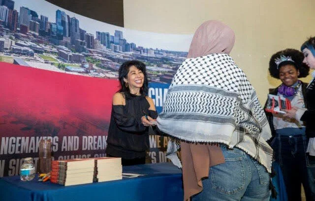 Loung Ung greeting readers at a book signing