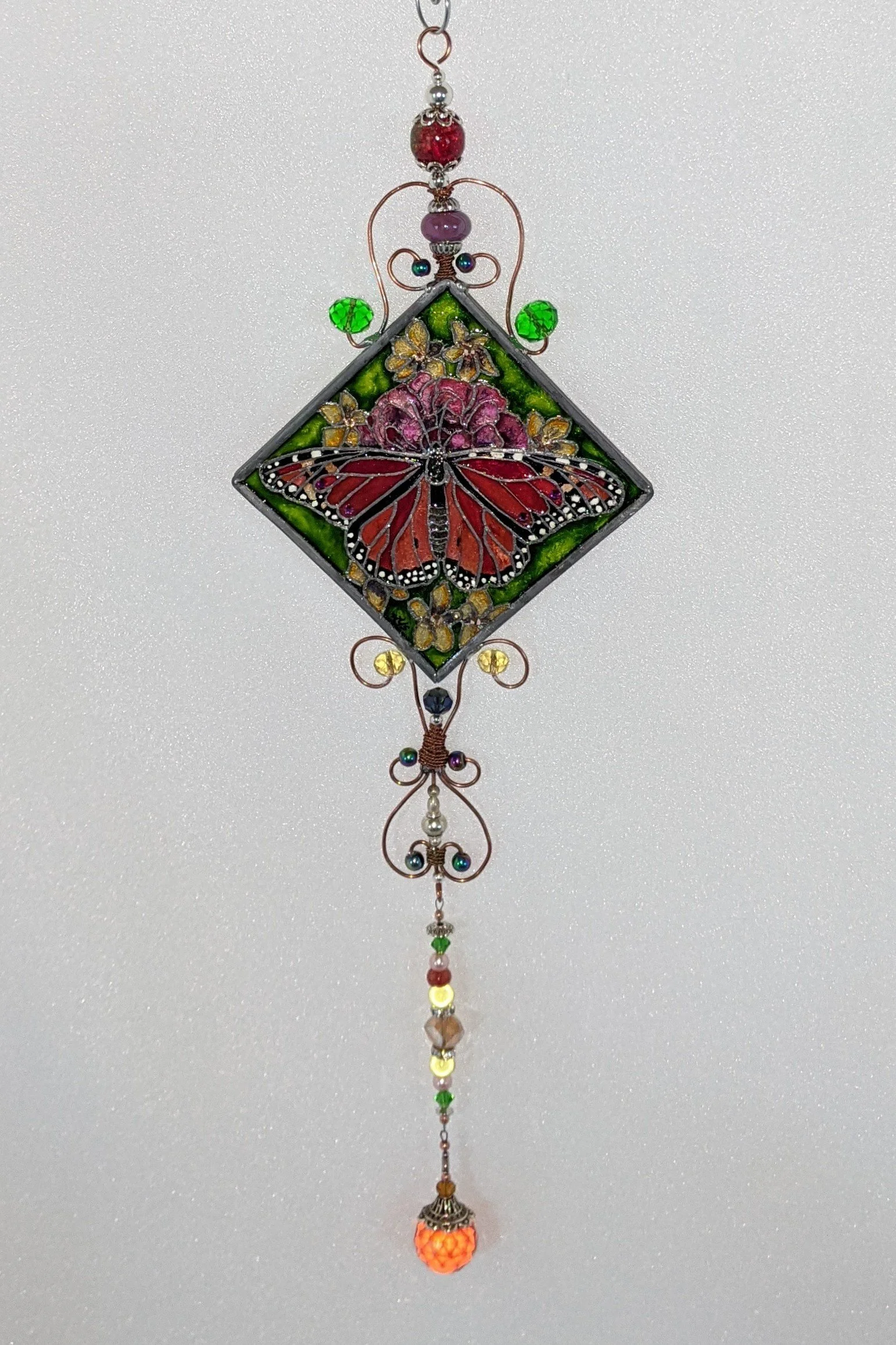 🔴 Sold: 
Red and Black Butterfly Illusion Glass by Art Illusions by Young. This striking diagonal suncatcher highlights a bold red-and-black butterfly with dramatic wing patterns and subtle sparkle accents. The vibrant contrast creates a powerful ye
