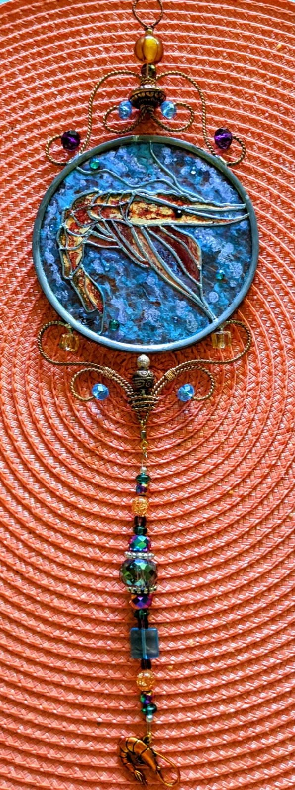 🔴 Sold: 
Shrimp Illusion Glass by Art Illusions by Young. This lively circular piece features fresh Louisiana shrimp with vibrant pink and orange tones against a coastal background. The detailed hand-painting celebrates the bounty of the Gulf in lum